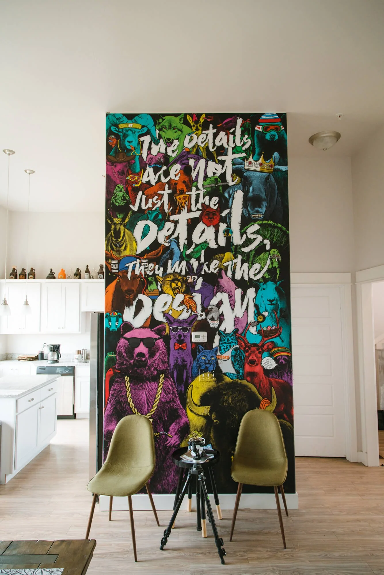 Vibrant wall wrap featuring a collage of neon-colored animals wearing accessories with large text reading “The details are not just the details, they make the design,” adding bold personality to the space. Installed at The Wrap Agency in Bozeman, MT.