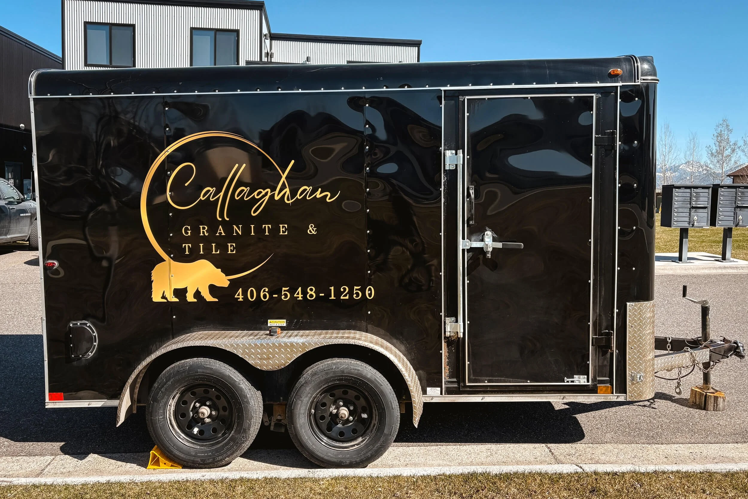 Callaghan Granite & Tile vinyl logo in a gold gradient on the side of a trailer