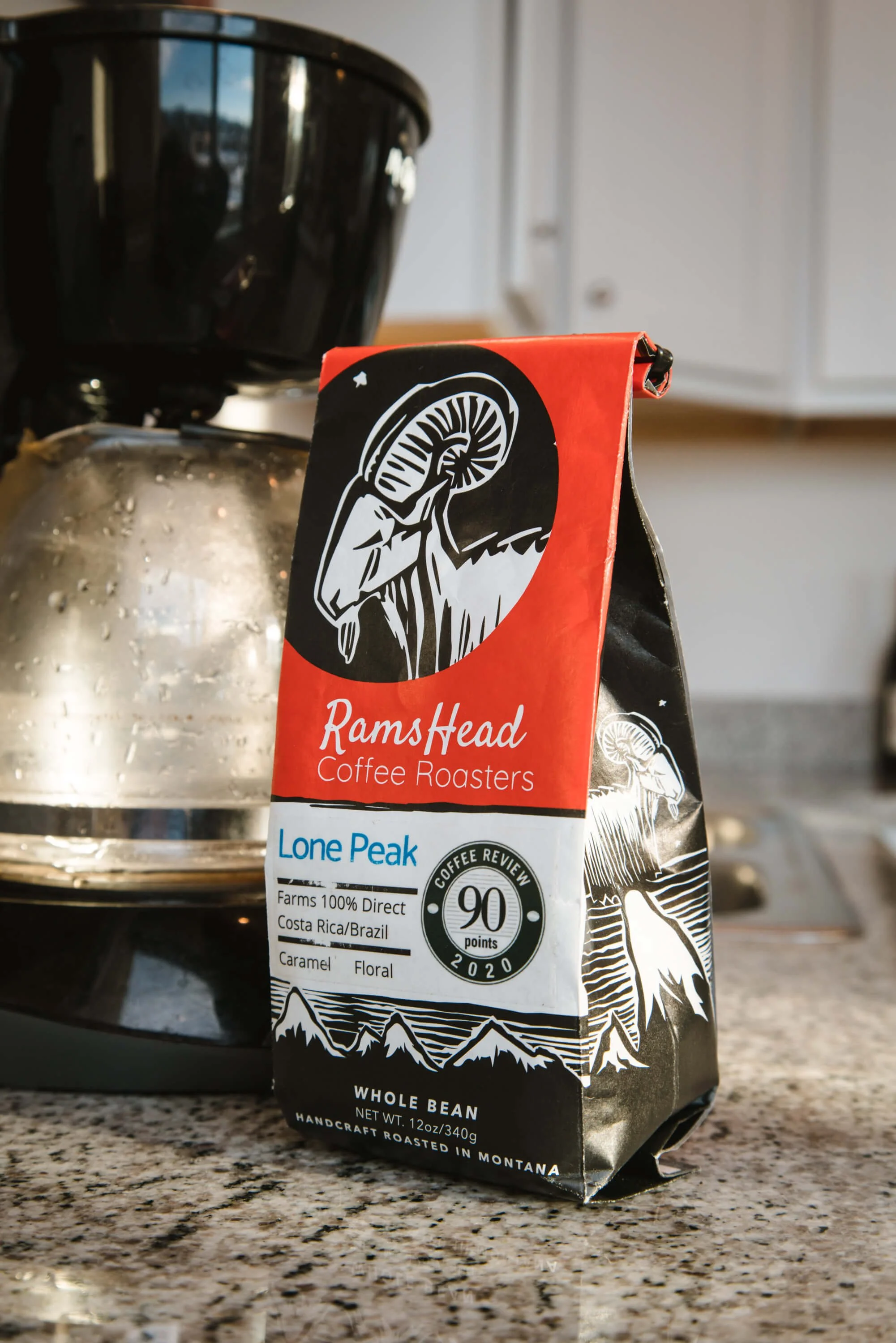RamsHead Coffee Roasters Lone Peak bag on kitchen counter next to coffee maker.