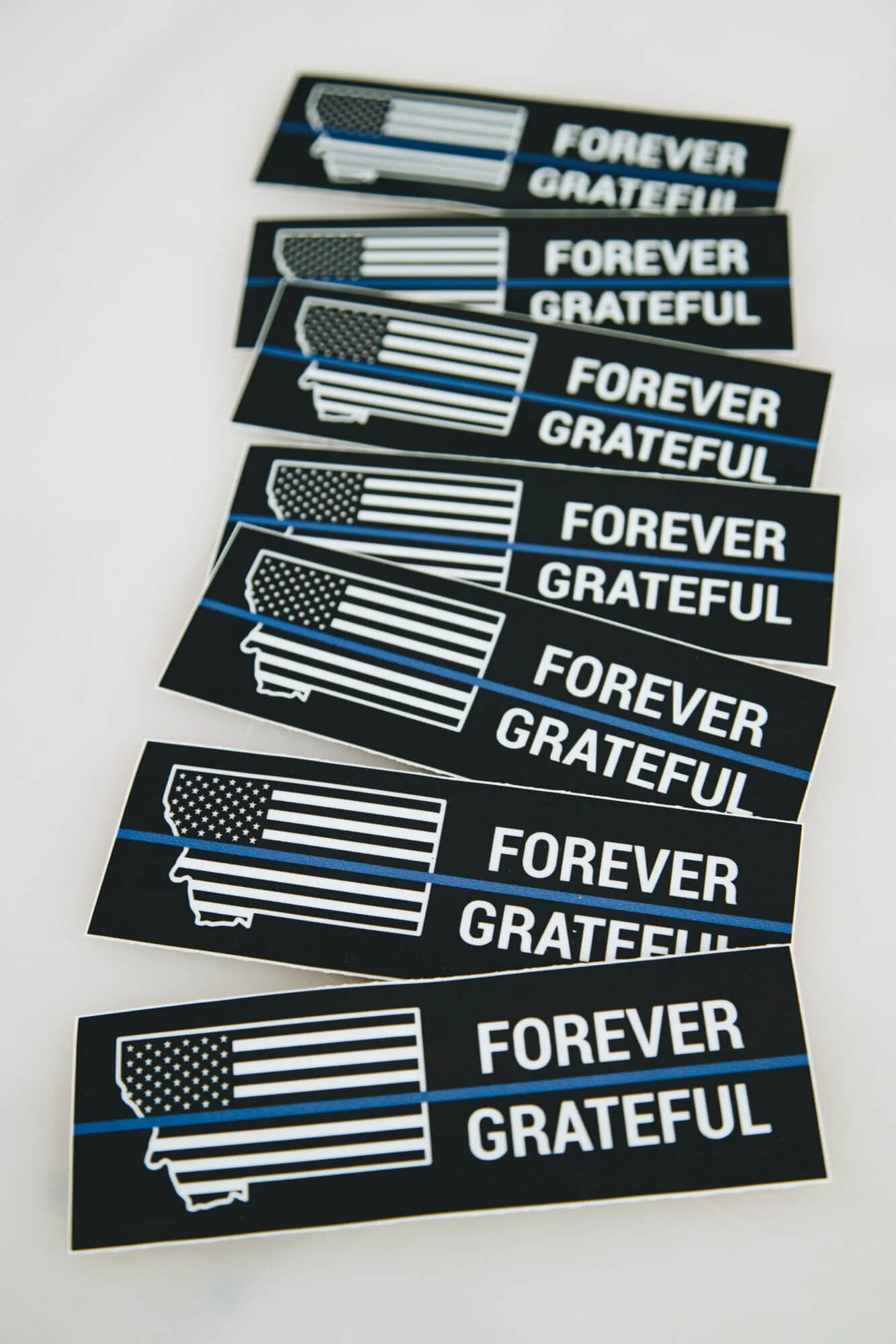 Custom stickers printed with American flag artwork and “Forever Grateful” messaging.