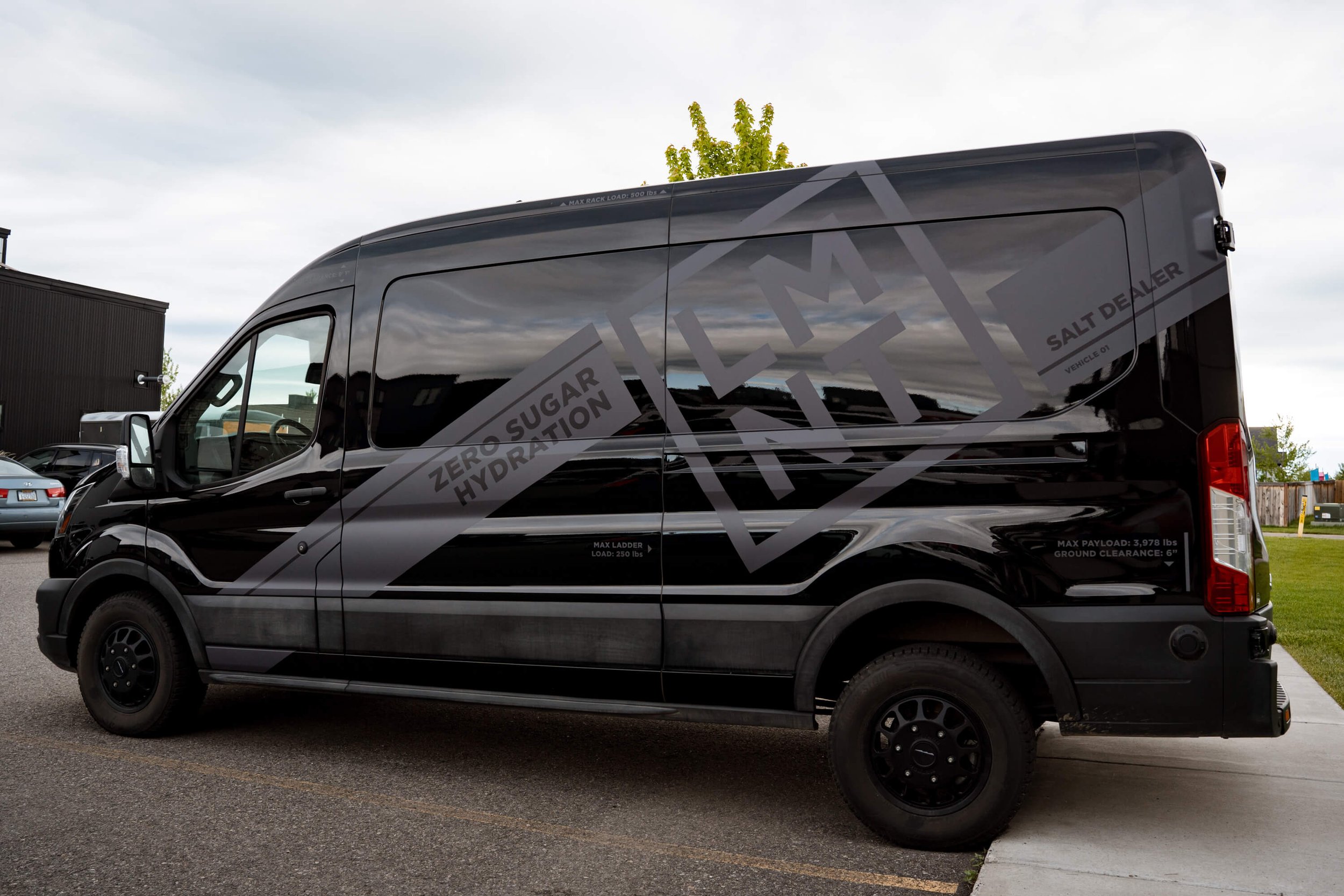 Matte black Ford Transit van vehicle wrap featuring subtle tone-on-tone LMNT Salt Dealer branding with “Zero Sugar Hydration” messaging in a sleek, minimalist design. Location: Bozeman, Montana
