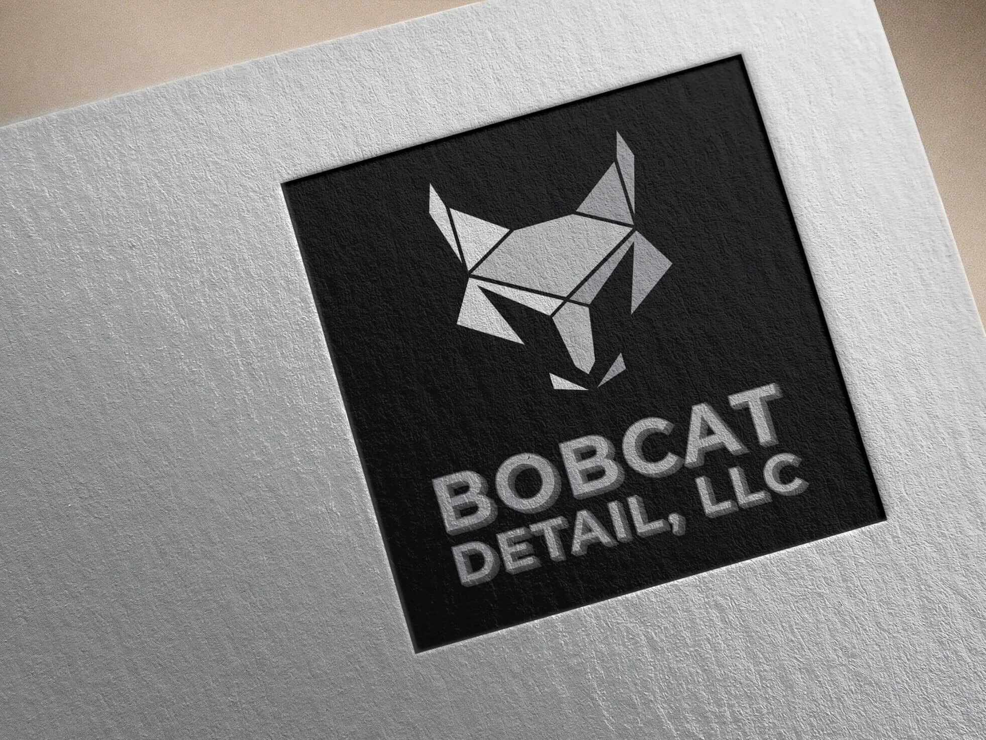 Geometric bobcat head logo with text BOBCAT DETAIL, LLC.