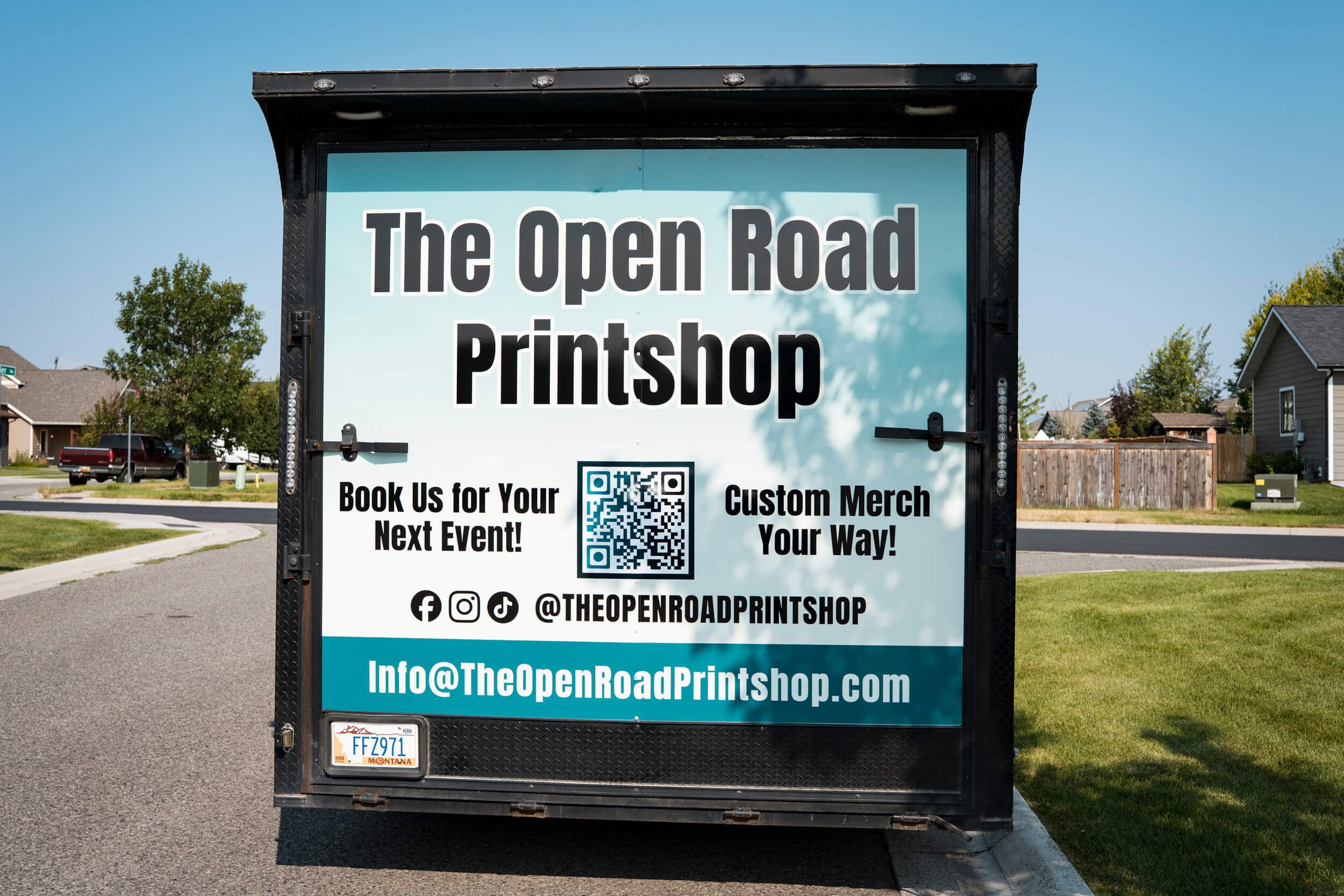Full vinyl wrap on the back of trailer for The Open Road Printshop. Includes contact info, QR code, and social links.