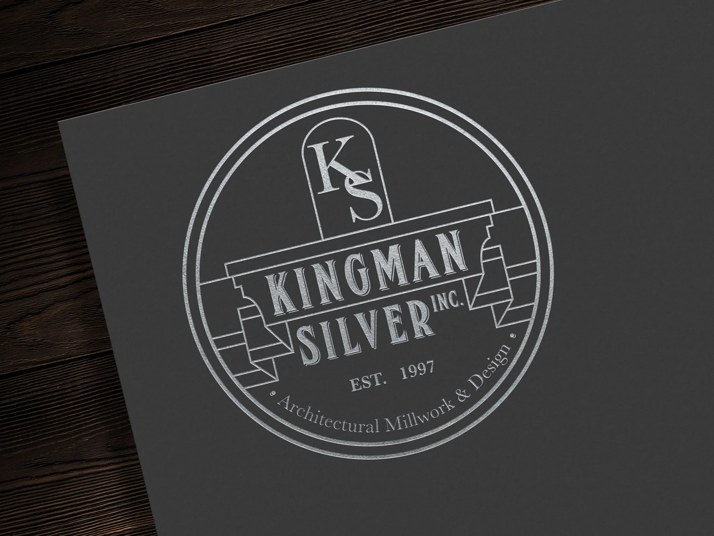 Logo for Kingman Silver Inc., established 1997, specialized in architectural millwork and design. It features a circular design with decorative elements.