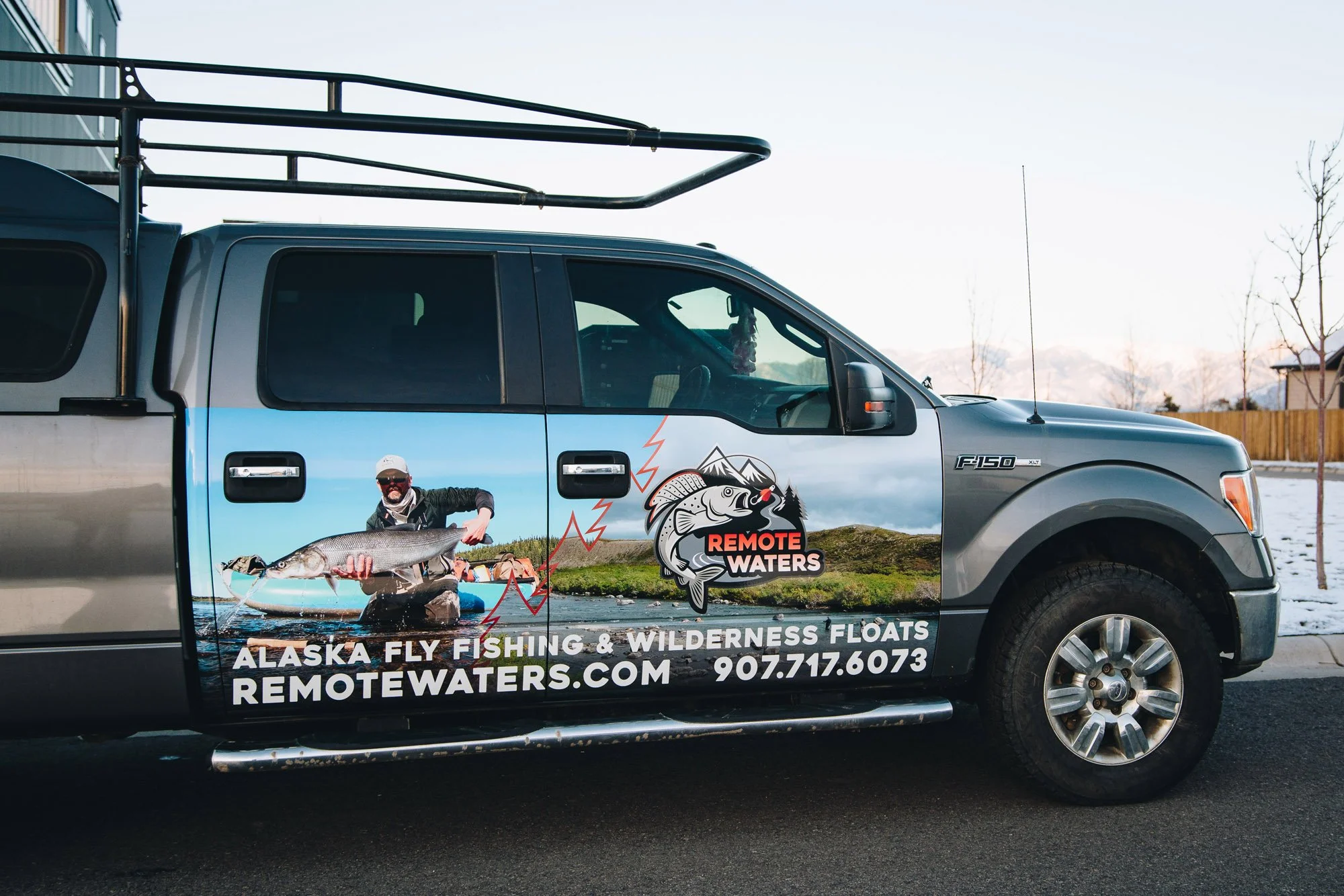 Full vinyl vehicle wrap for Remote Waters in Bozeman, MT, displaying vivid Alaska fly fishing imagery and branding on a Ford F-150, perfect for promoting wilderness float adventures.