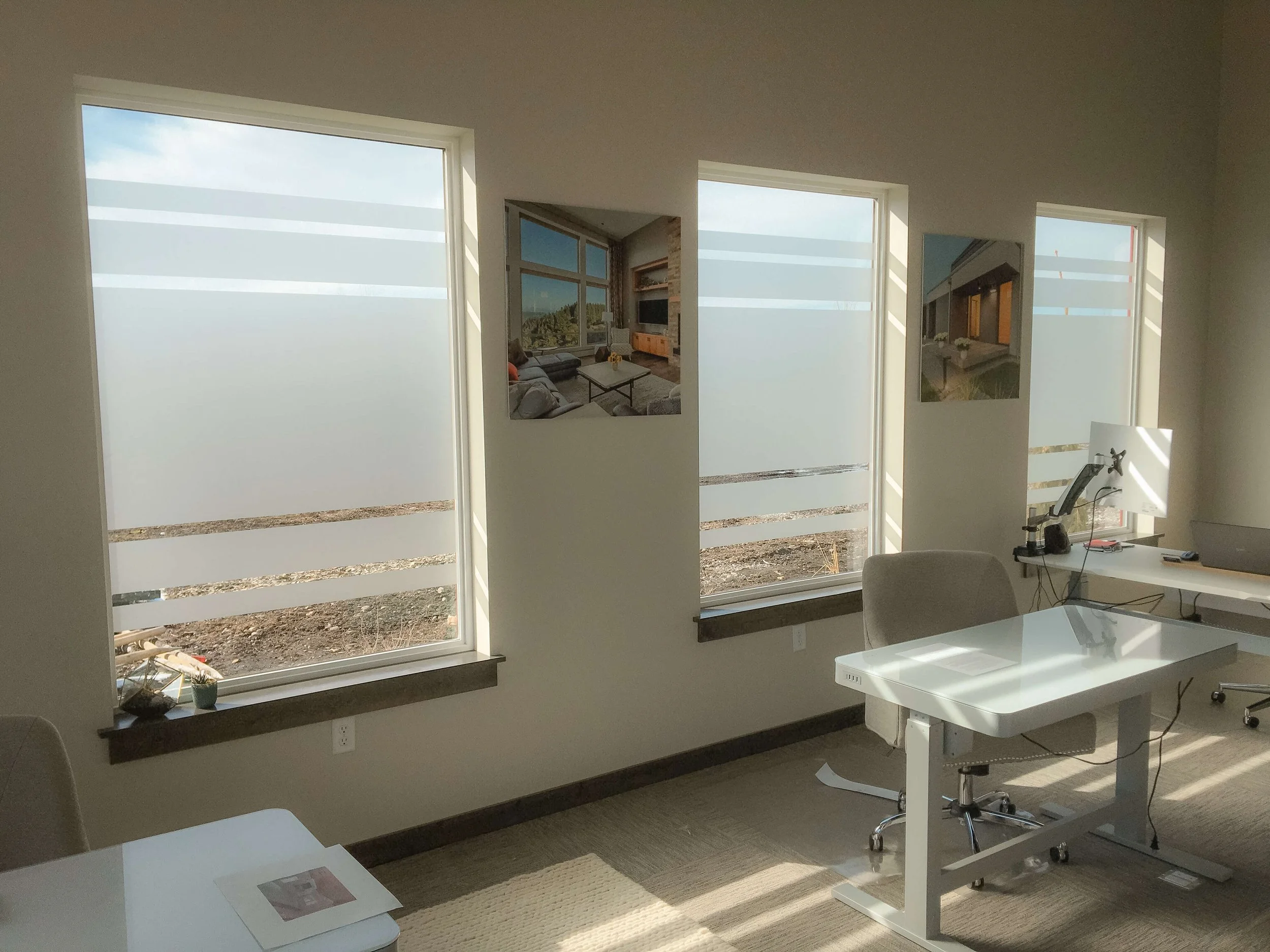 Office window graphics with dual horizontal frosted bands on multiple windowpanes, offering a cohesive privacy solution while allowing natural light.