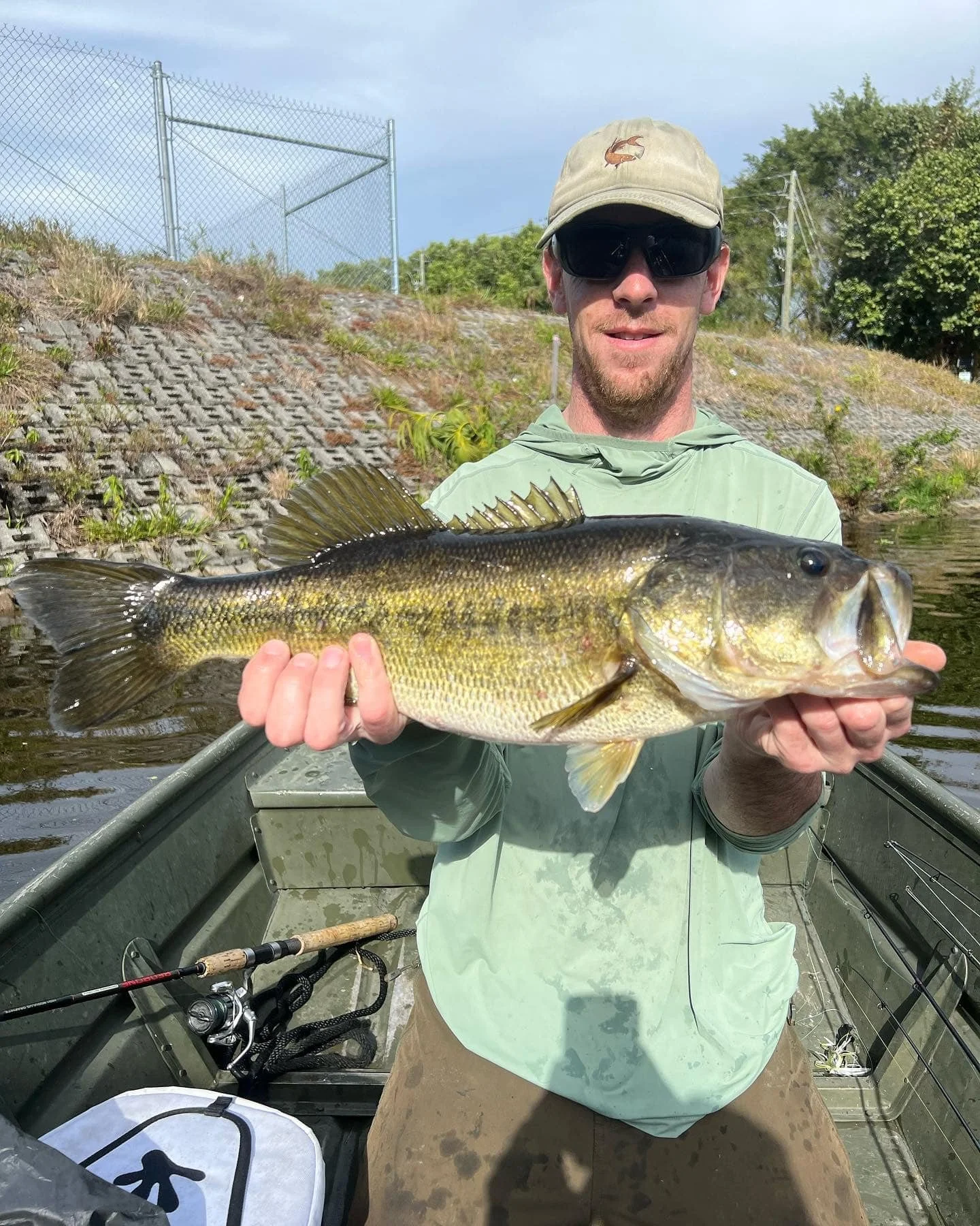 Maine Fishing Guide Brandon Bichrest With a large Mouth Bass caught in a canal in southern Florida