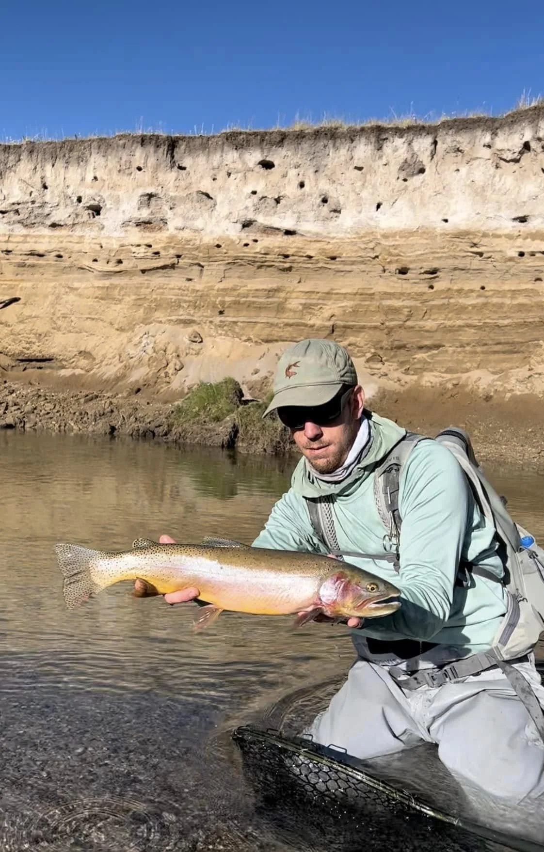 Maine Fishing Guide Brandon Bichrest with a 23" Yellowstone CutThroat Trout caught on a Fly