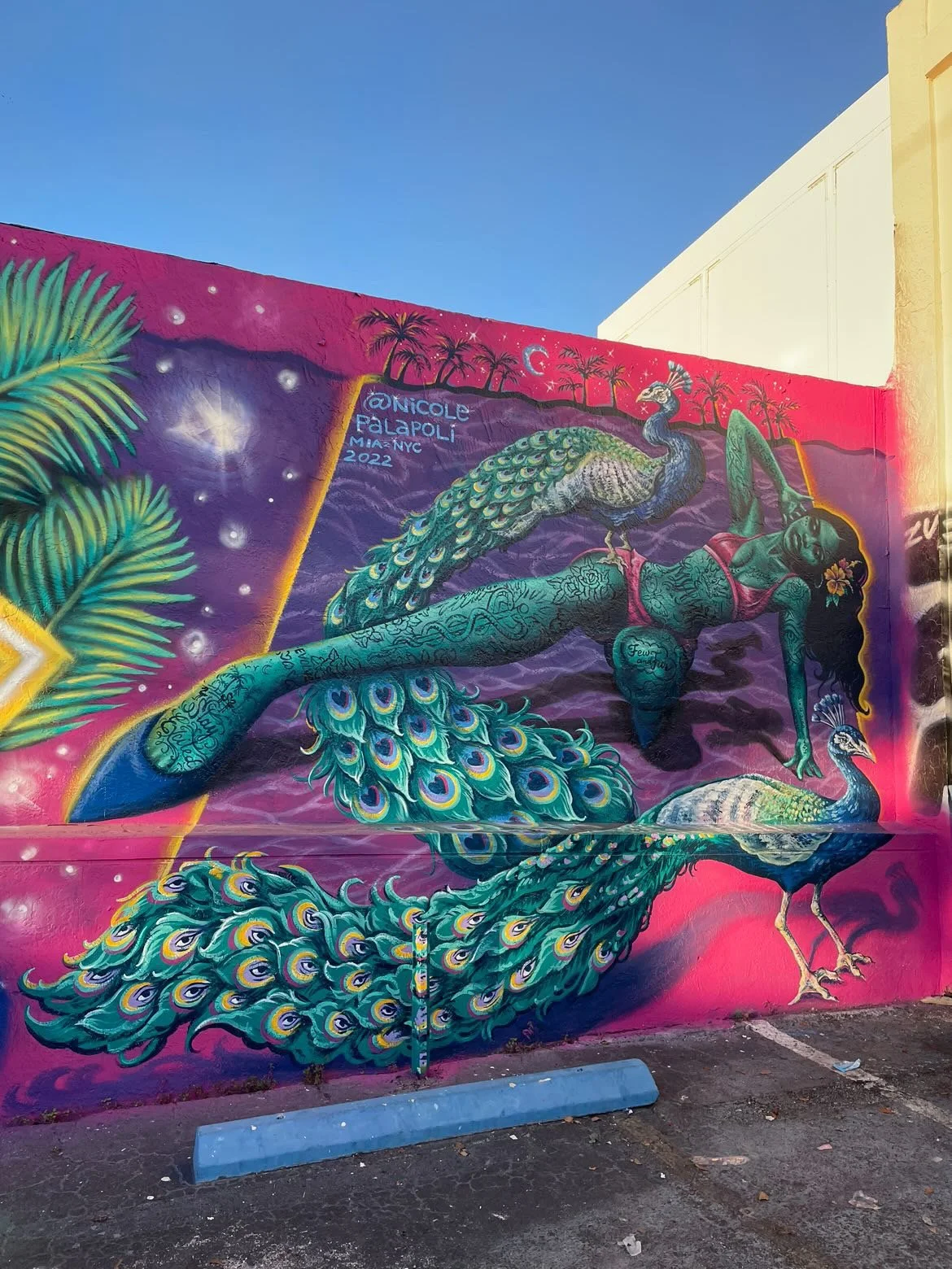 Mural by Nicole Palapoli: peacock mermaid, exterior wall