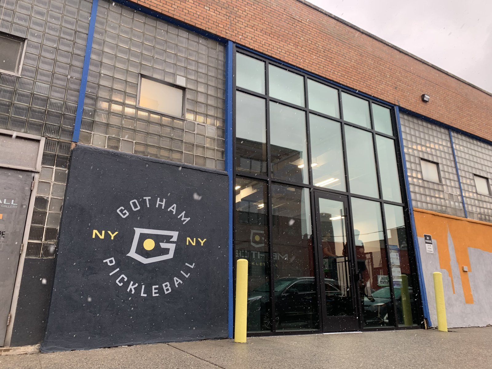 Mural by Nicole Palapoli: Gotham Pickleball sign on a brick building