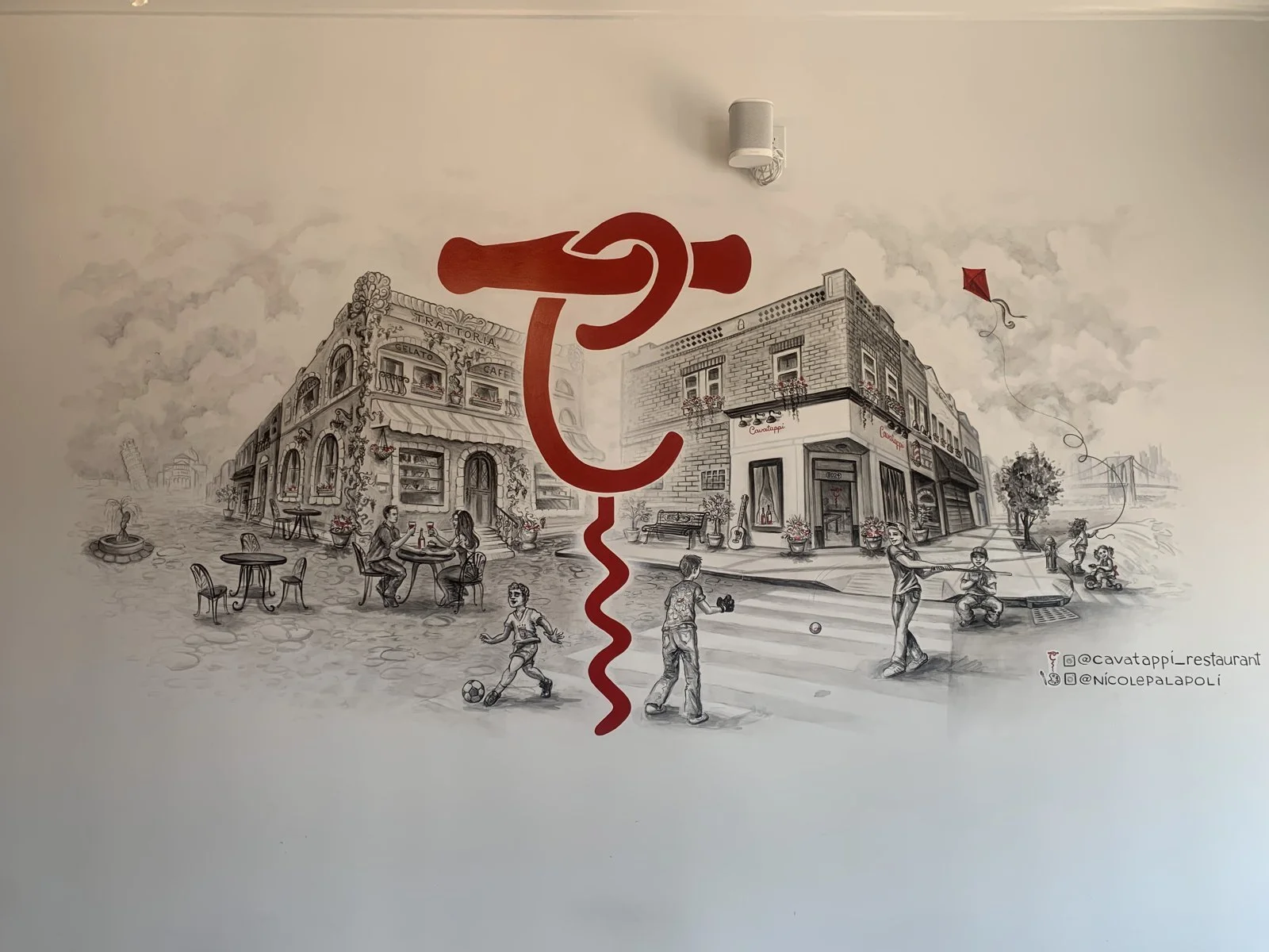 Mural by Nicole Palapoli: black and grey street scene with logo, interior wall