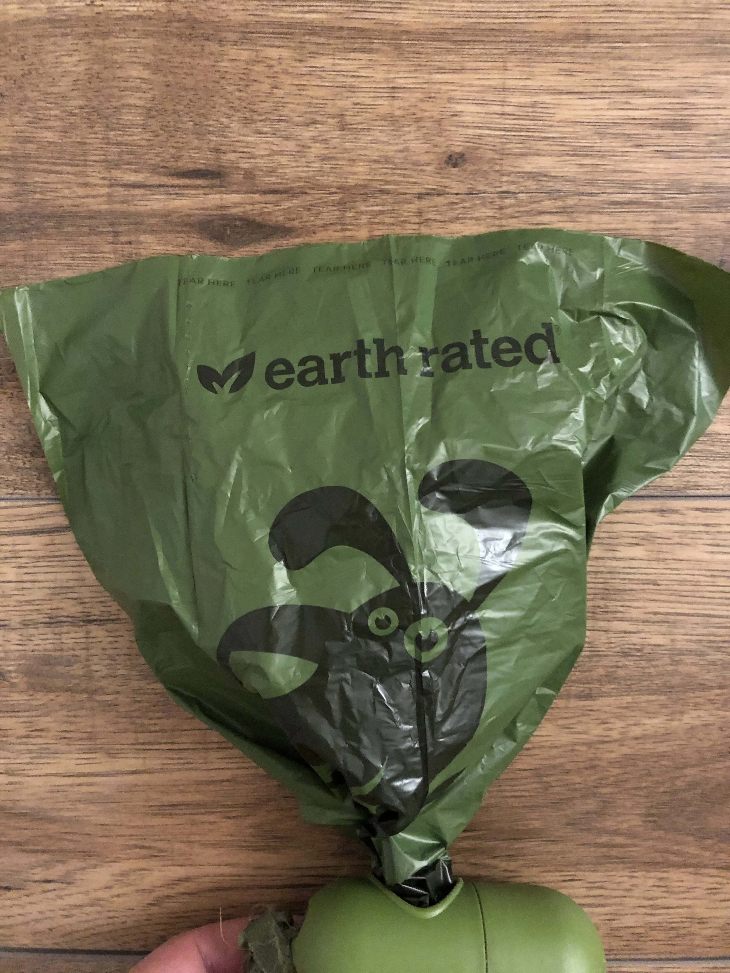 The Earth Rated Dog Poop Bag halfway pulled out of the dispenser