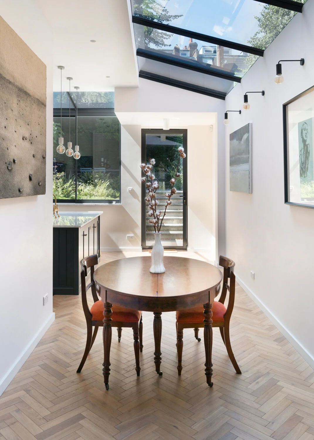 Gladsmuir Road, Islington: a side return dining extension where roof glazing brings daylight into the centre of a narrow Victorian plan. Space, light and movement need to be designed together.