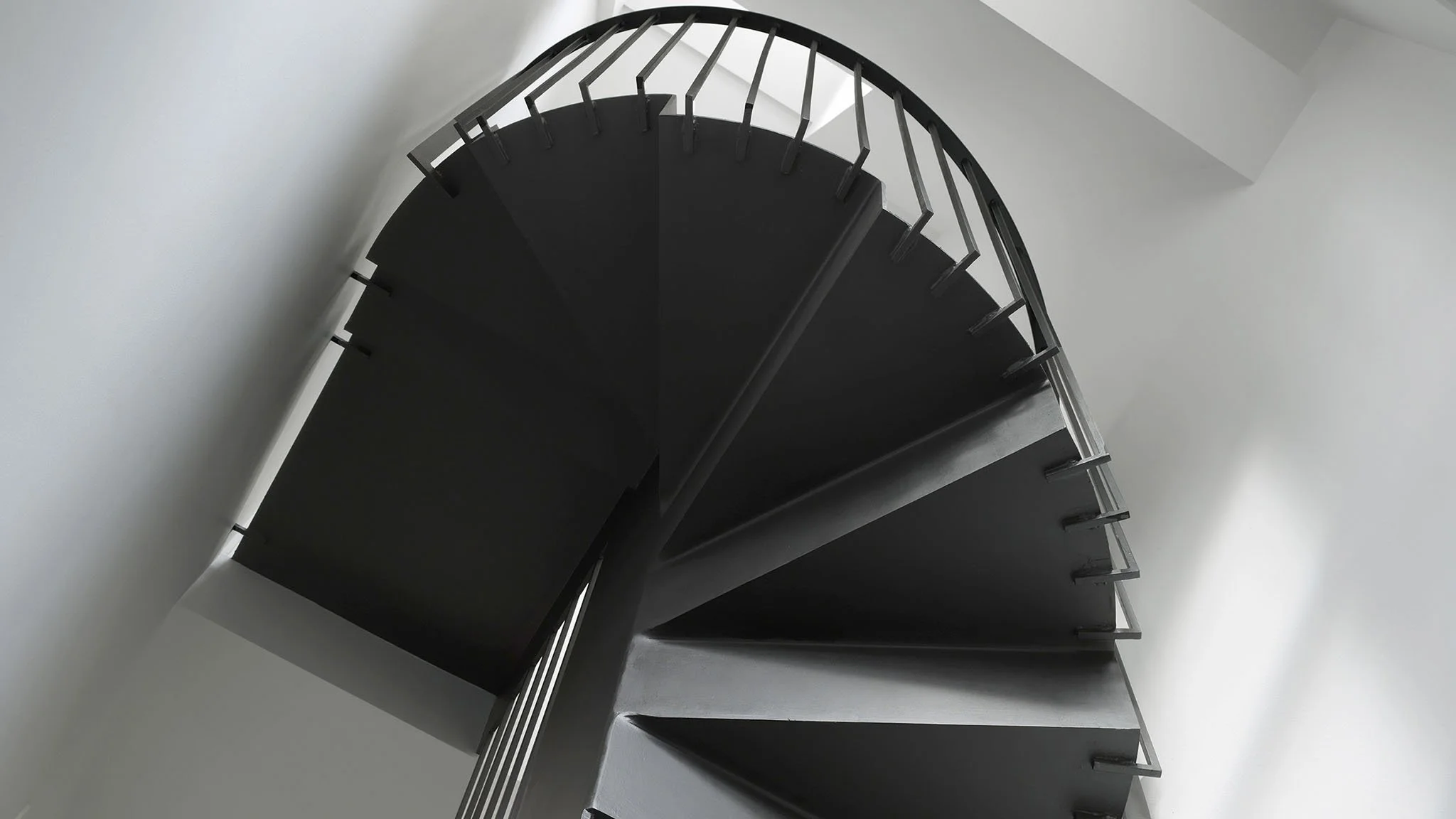 Cantilevered black staircase at Prebend Street, Islington, designed to bring light through the centre of the Victorian terrace.