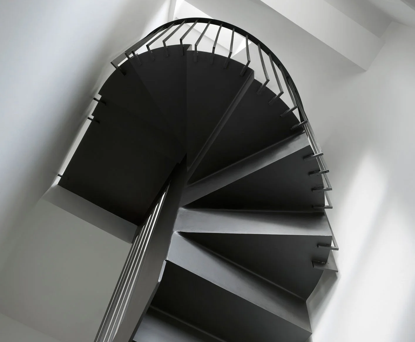 Compact steel stair within a Victorian terrace, showing tight circulation and sectional constraints prior to the loft reworking.
