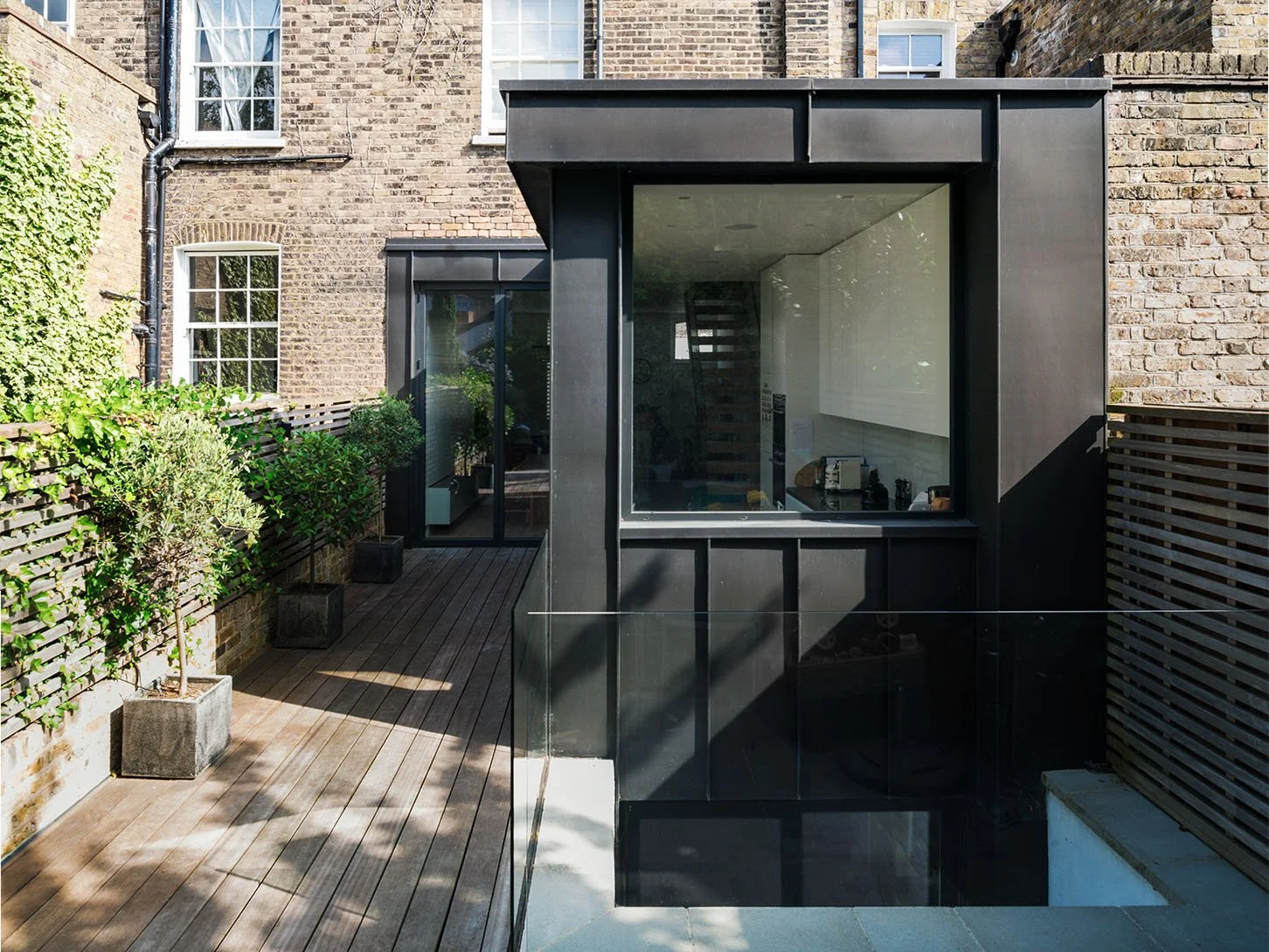 Zinc-clad rear extension and basement courtyard at St Paul Street, an Islington Victorian terrace renovation by Studio CMA.