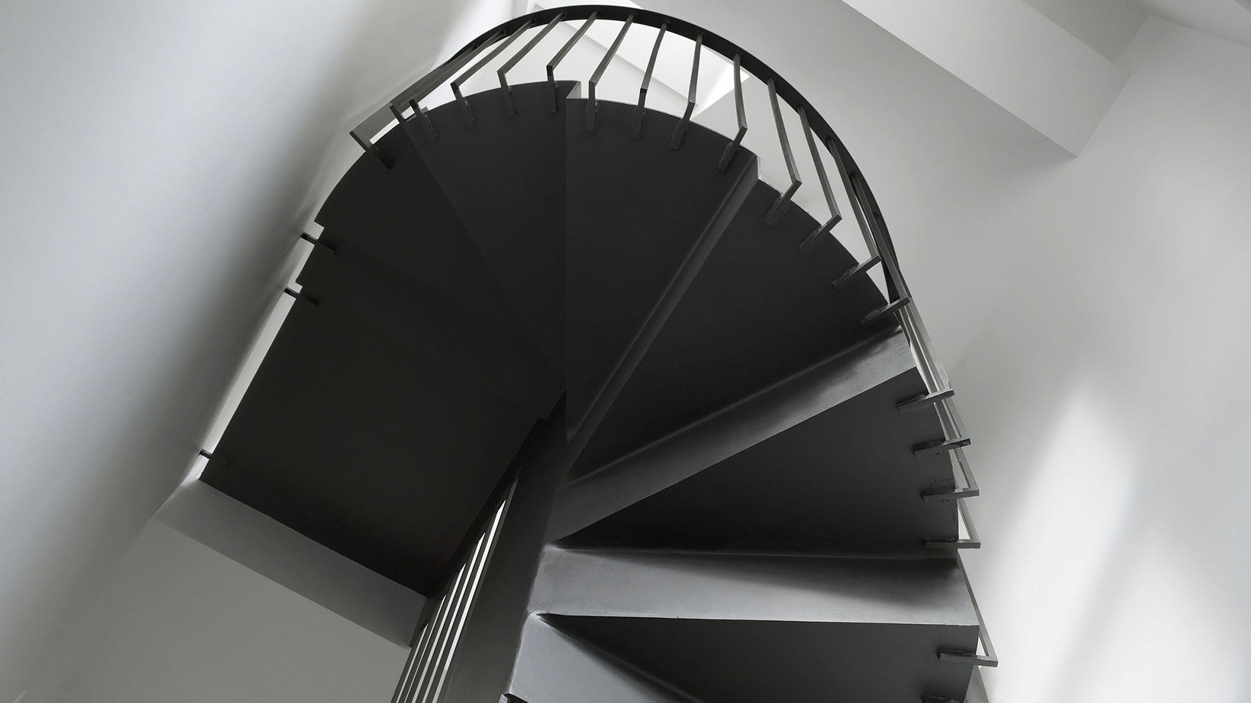 Compact folded steel stair in a Victorian terrace loft extension at Prebend Street in Islington