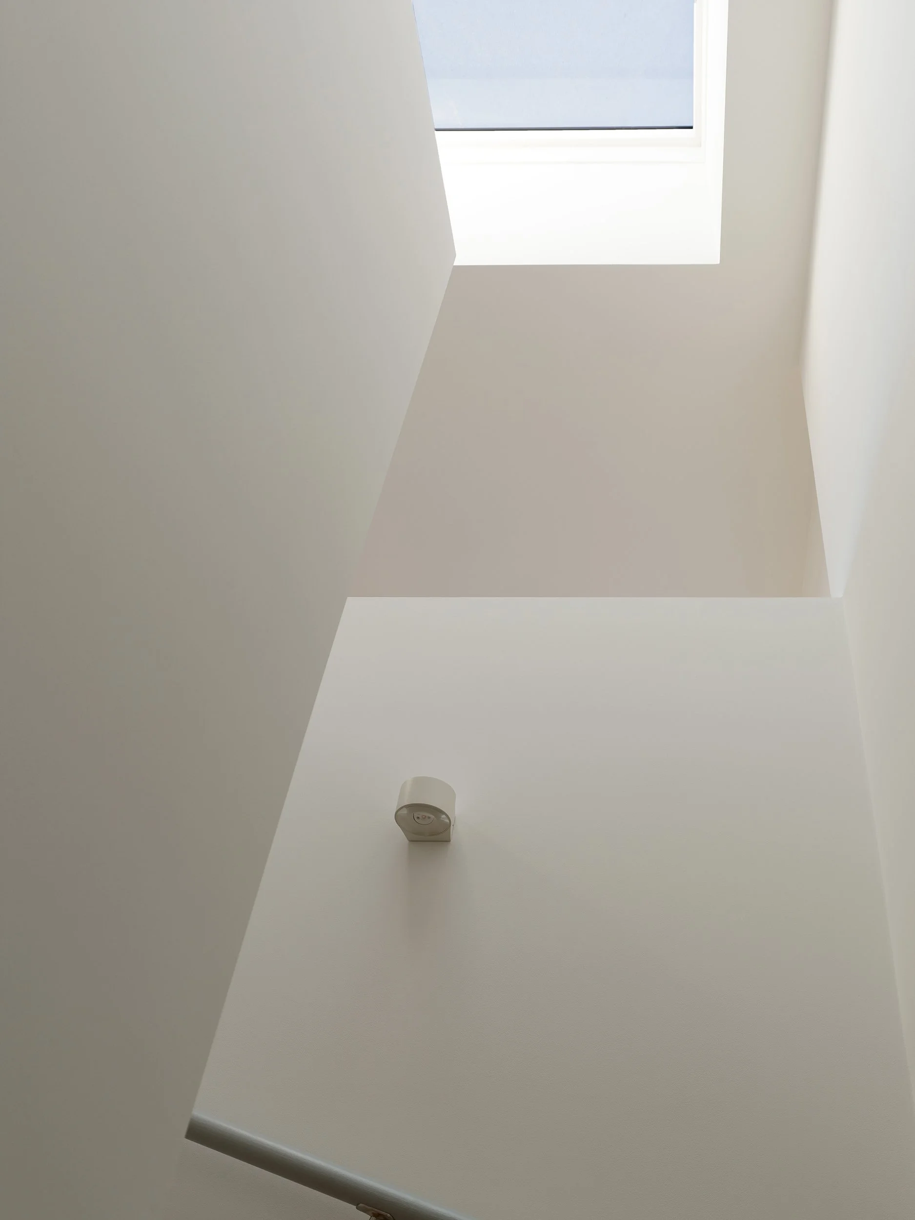 Central stair and circulation core within the roof extension, lit by a rooflight to bring daylight into the heart of the upper floor in Hackney.