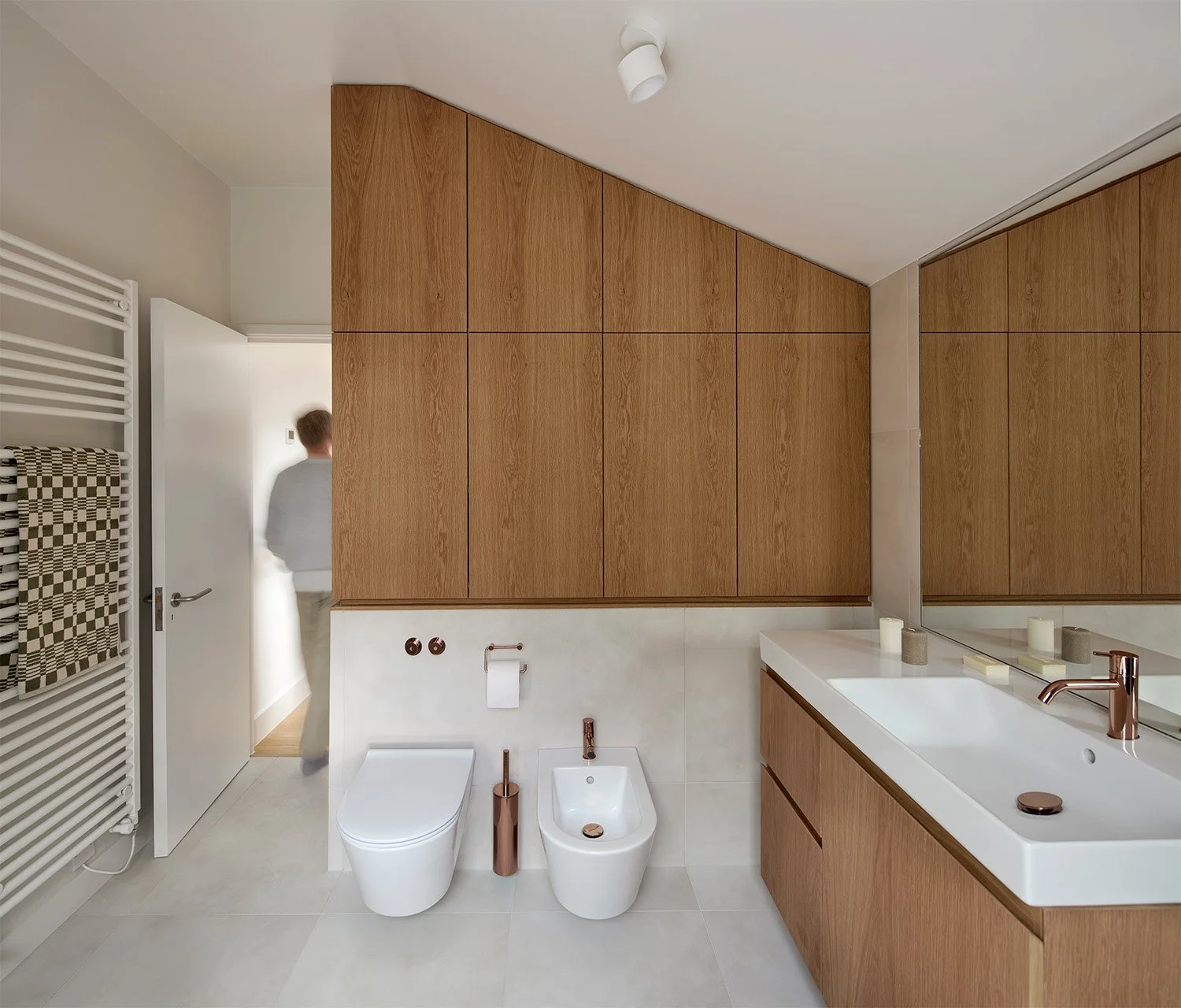 Bathroom in a renovated Victorian London home with timber cabinetry and natural light