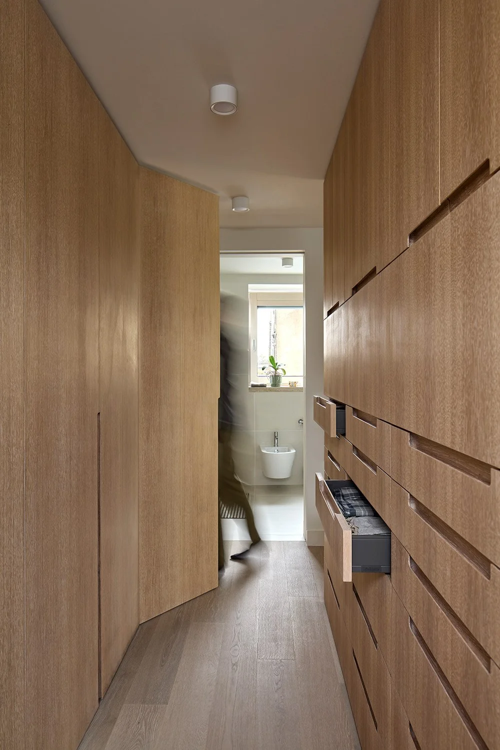 Narrow timber-lined corridor in a Victorian London house showing depth and spatial constraints