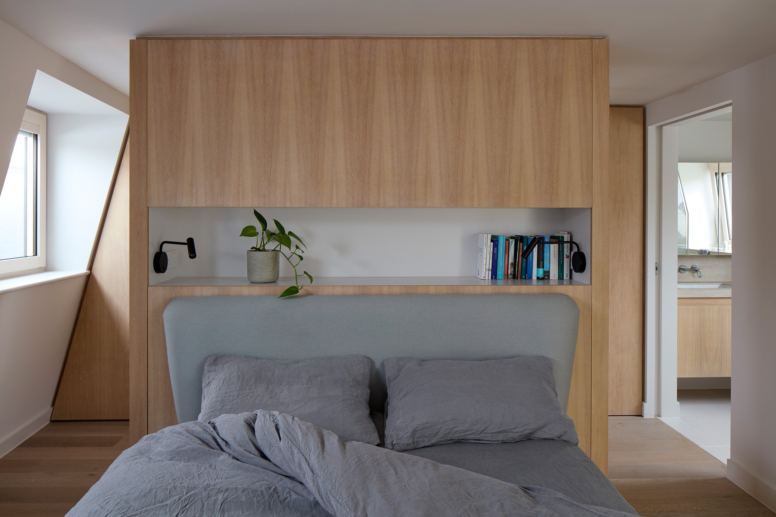 Light retrofit bedroom in Hackney with integrated joinery, improved insulation and refined spatial layout