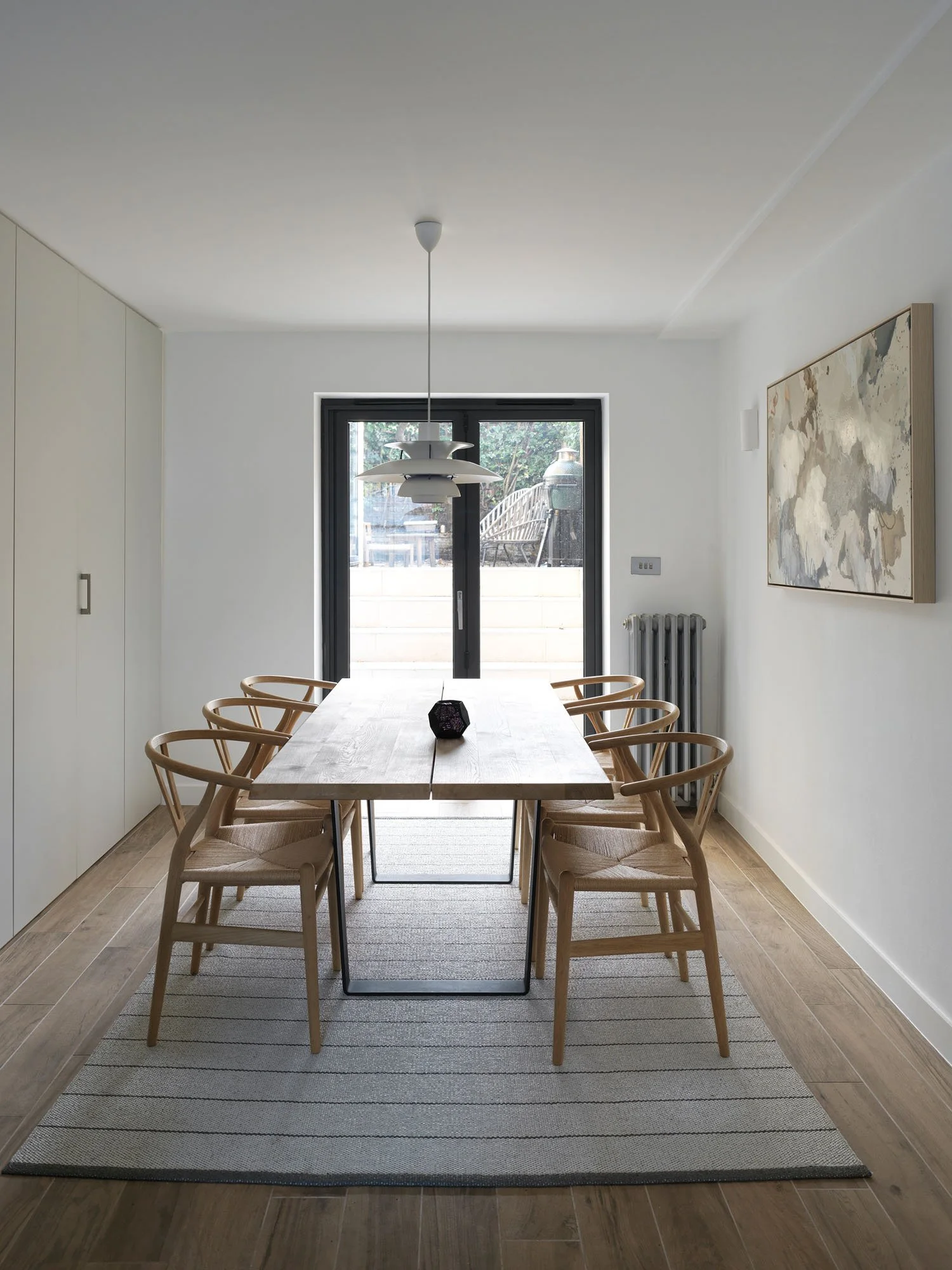 Glazed internal doors separating the stair and kitchen in a Victorian terrace, supporting fire safety and whole-house circulation.