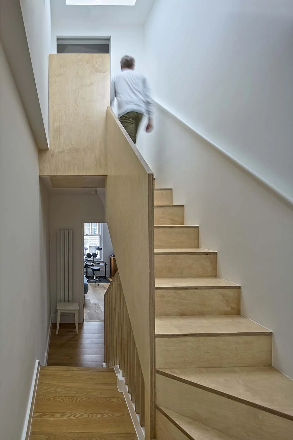 Compact plywood stair with rooflight in a Lower Clapton loft extension by Studio CMA