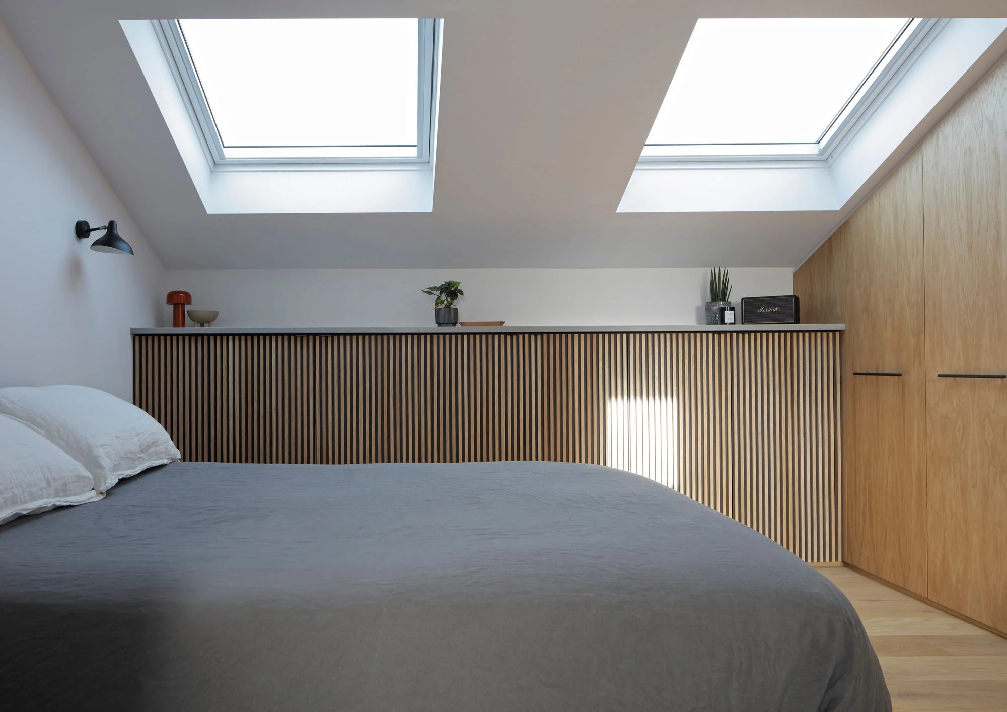 Loft bedroom in a Victorian terrace showing how ceiling heights and section were carefully recalibrated.