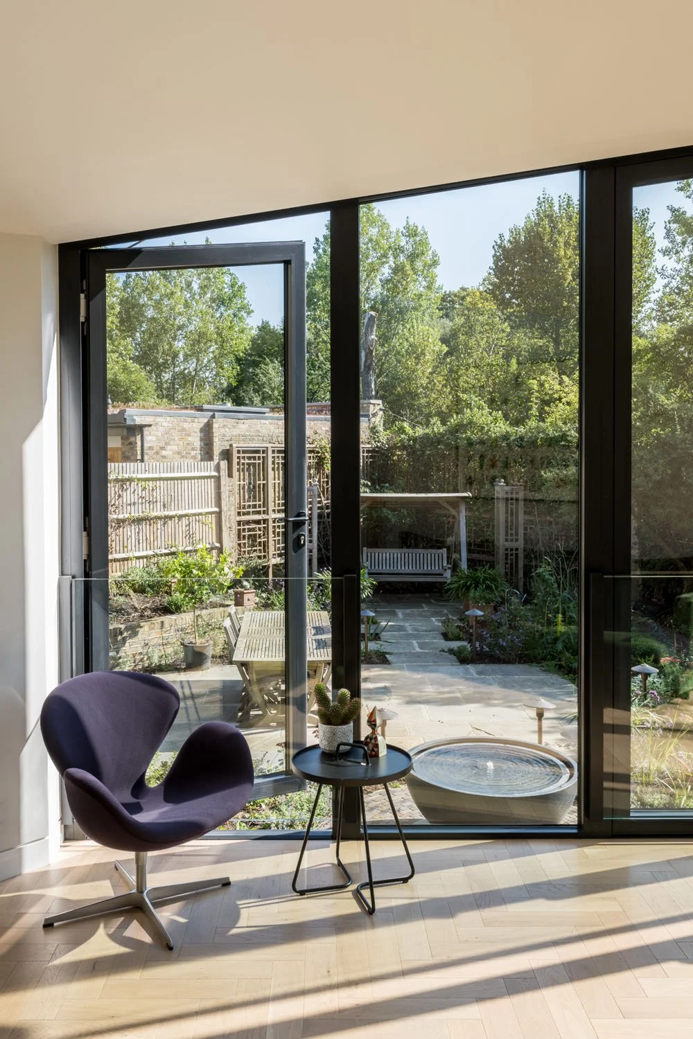 Highly glazed garden room with solar control glass and opening windows designed to reduce overheating risk