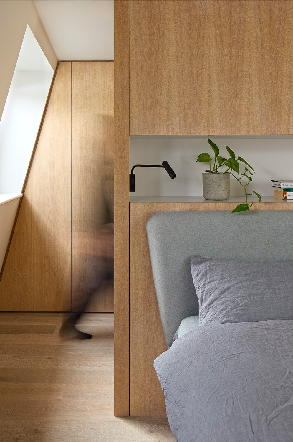 Loft bedroom with integrated timber joinery in a Victorian family home retrofit in Hackney.