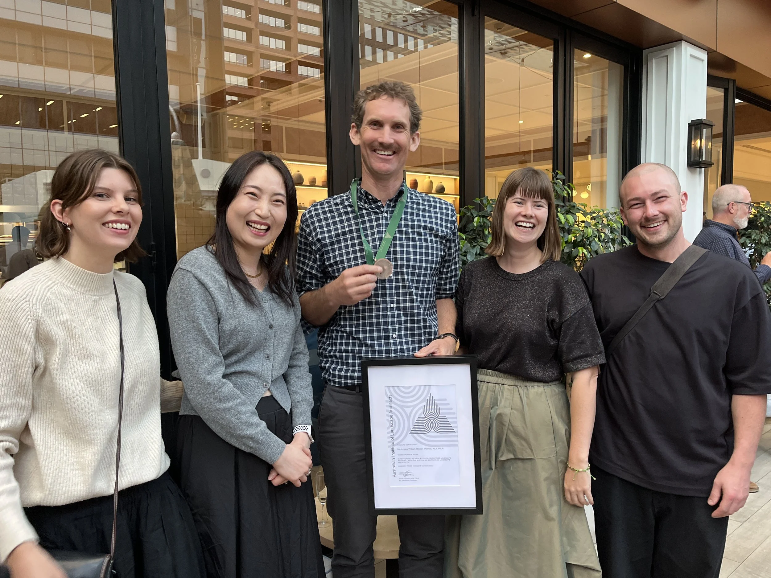 Four Landscape Studio staff from left; Rose, Sharon, Andrew with his fellowship award, Tilly and Nic.