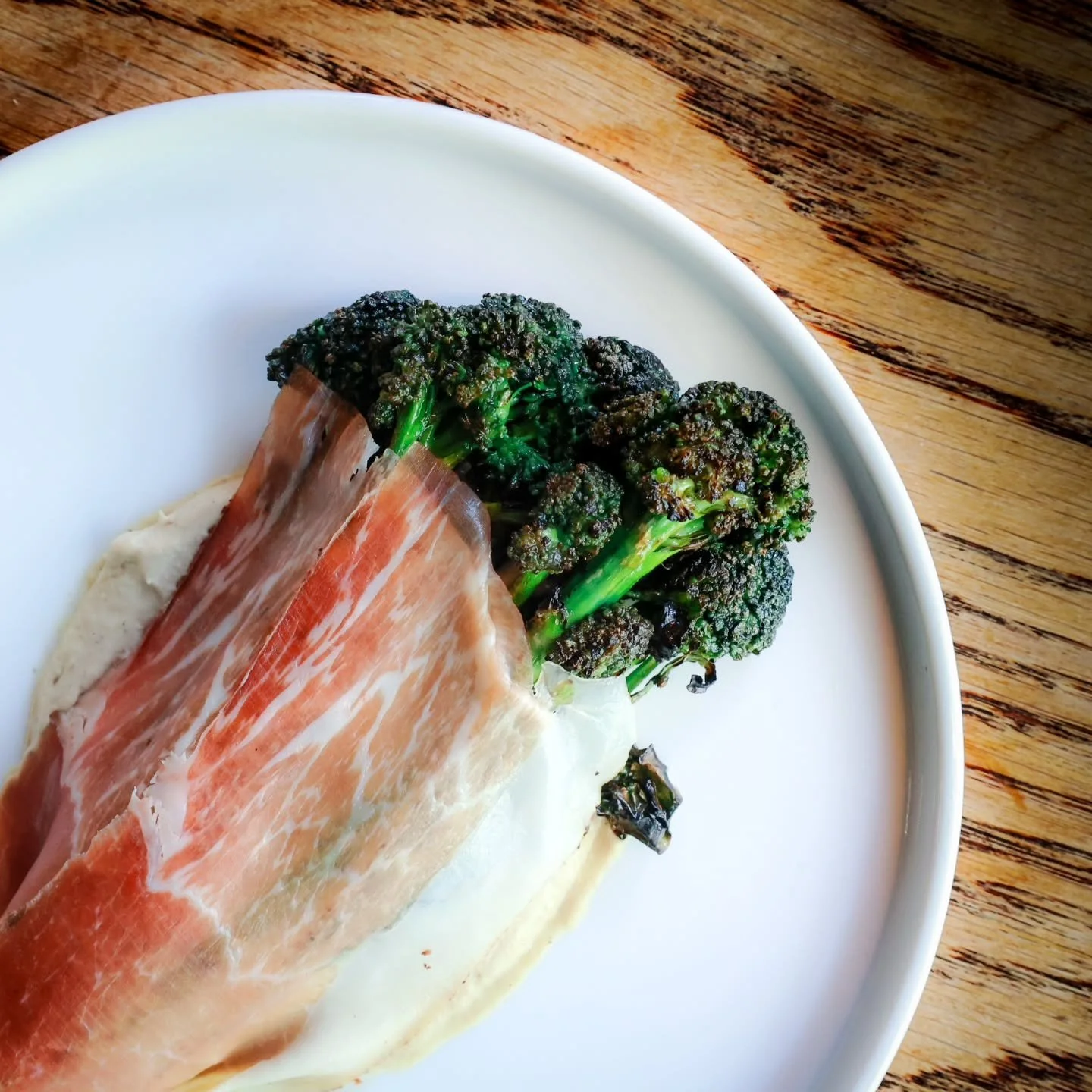 A dish that appears deceptively simple yet delivers extraordinary depth. 

It&rsquo;s all about the layers of flavour.

Smoked aubergine and garlic pur&eacute;e, tenderstem broccoli kissed by the flames, glazed with our in‑house fermented garlic and 