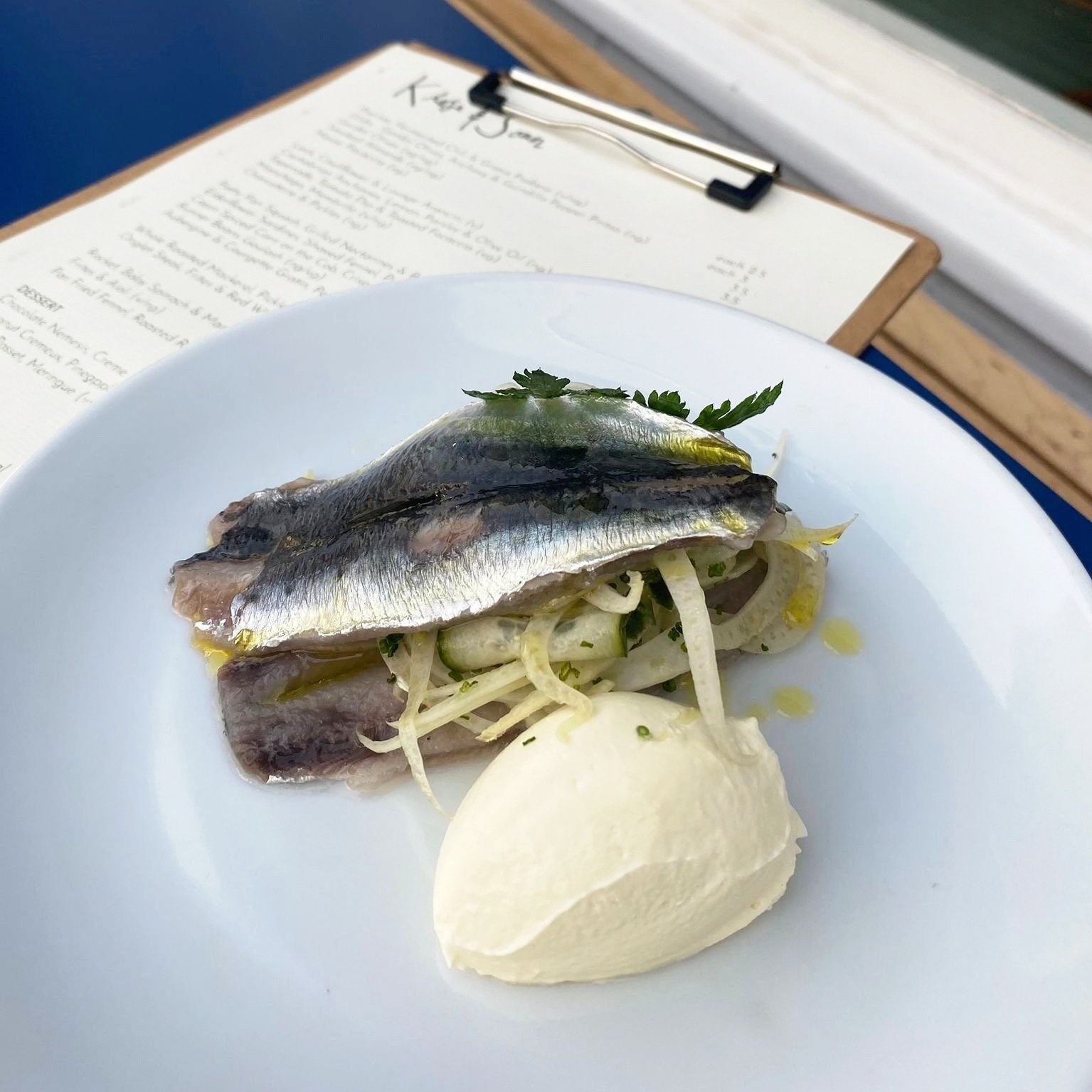 Sardines fillet marinated in elderflower, served with shaved fennel, pickled cucumber &amp; crème fraîche 