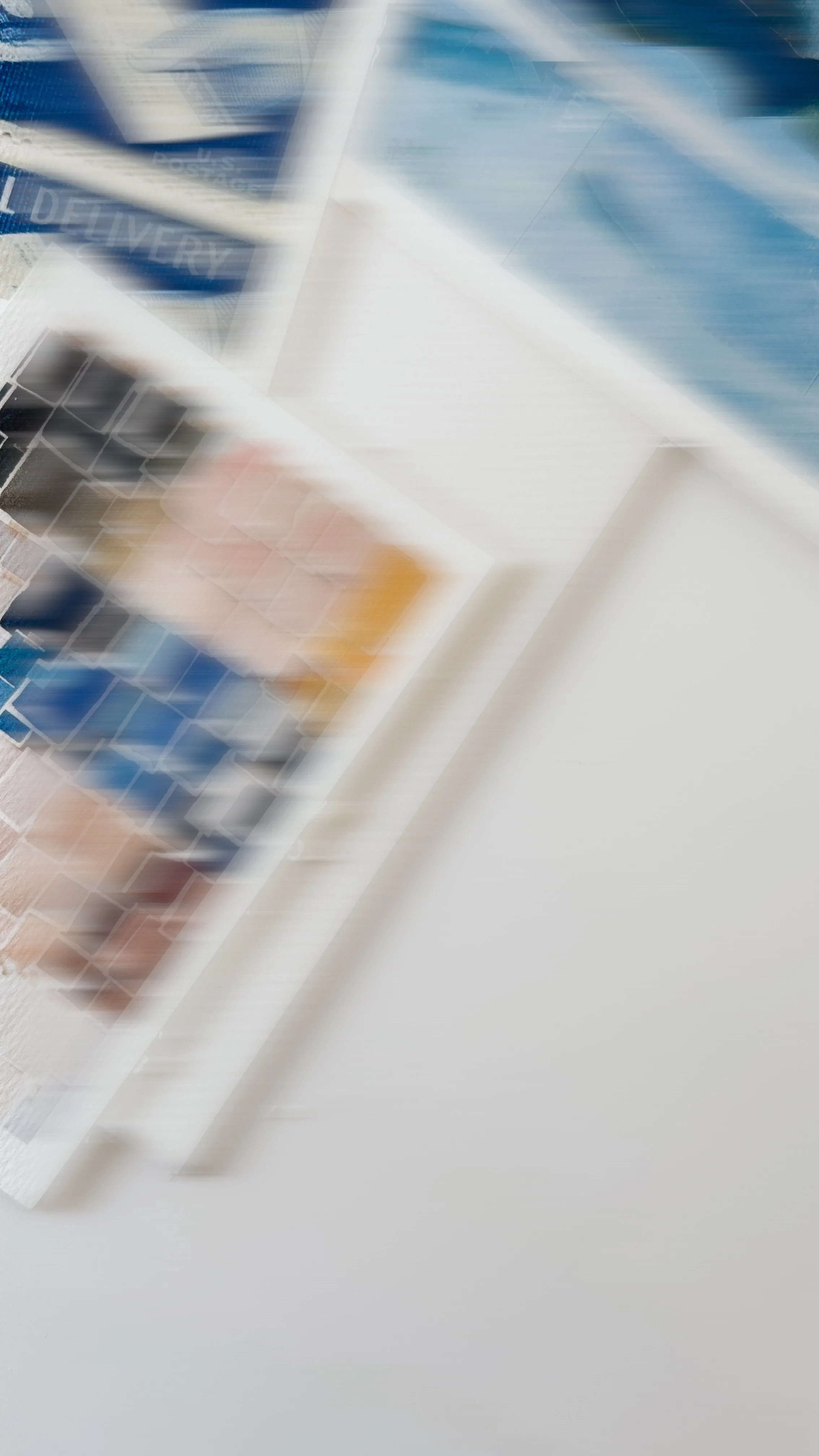 Blurred image of some books on a white surface.