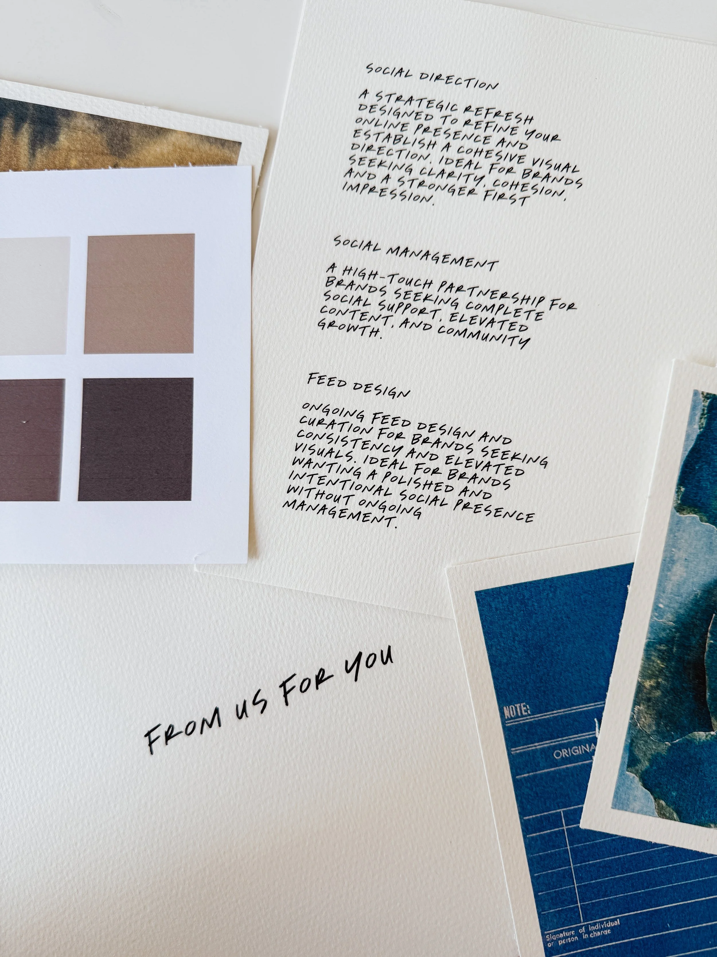 Close-up of a set of printed photographs and notes. The notes are handwritten, discussing topics like social direction, social management, and feed design. One photograph shows a color palette with six shades, ranging from light beige to dark brown, and another photograph displays a blue textured surface with graphs or charts.