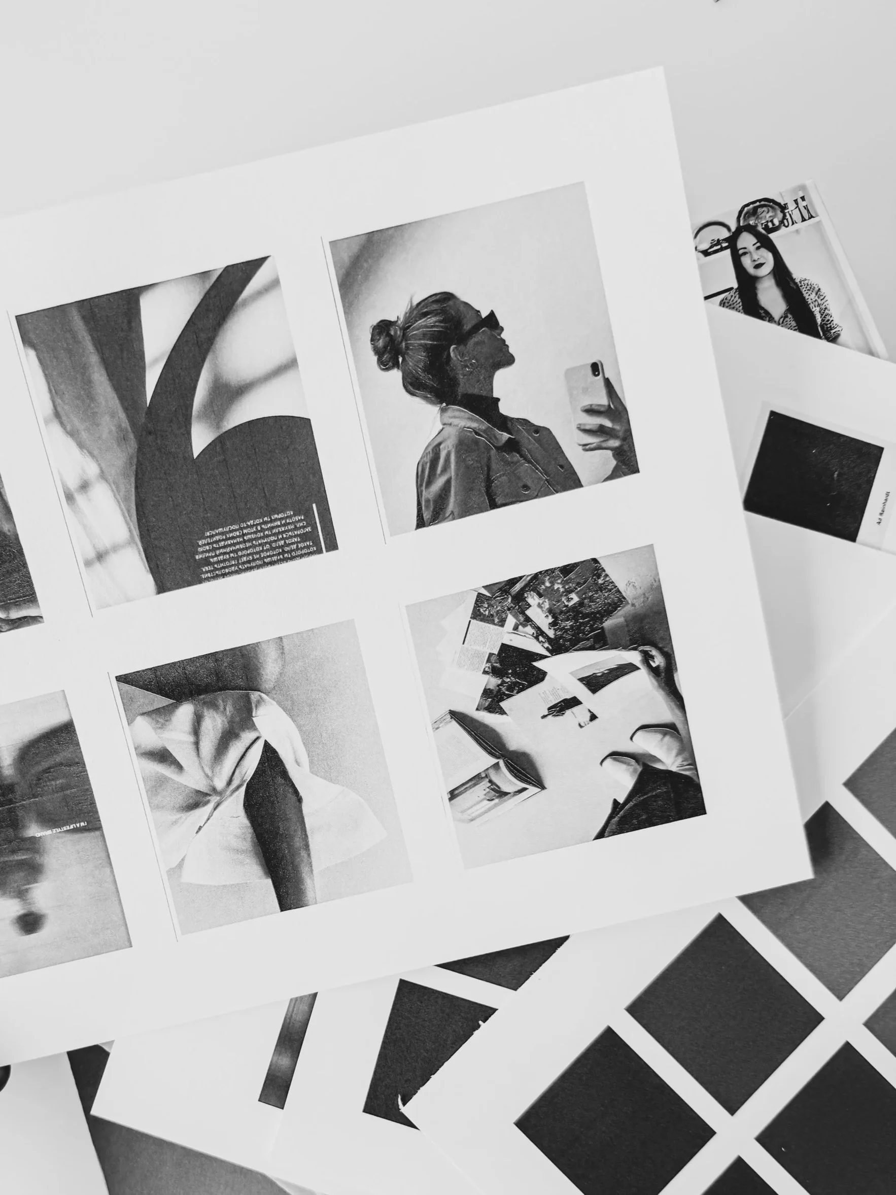 Close-up black and white photographs on paper, featuring various portraits of women, some taking selfies and others posing, laid out on a surface.