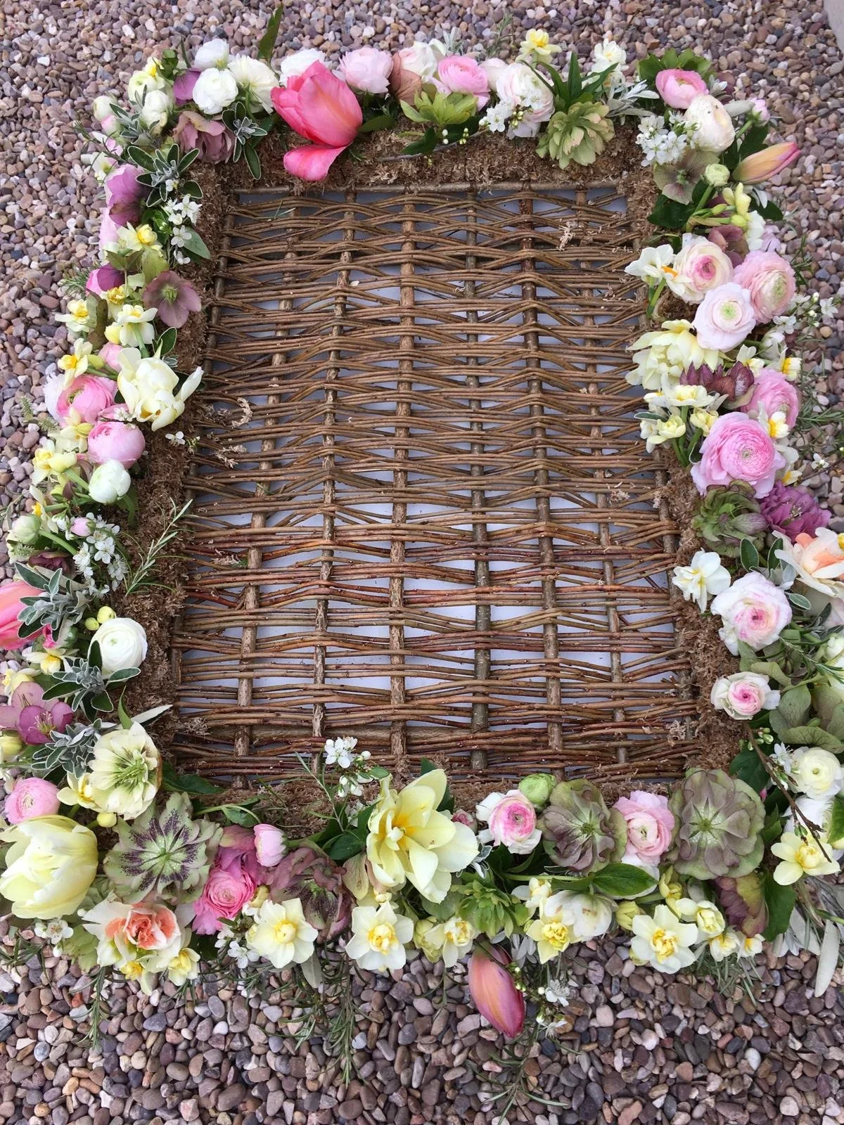 Willow bier for a baby's coffin decorated with spring flowers. Not compostable.