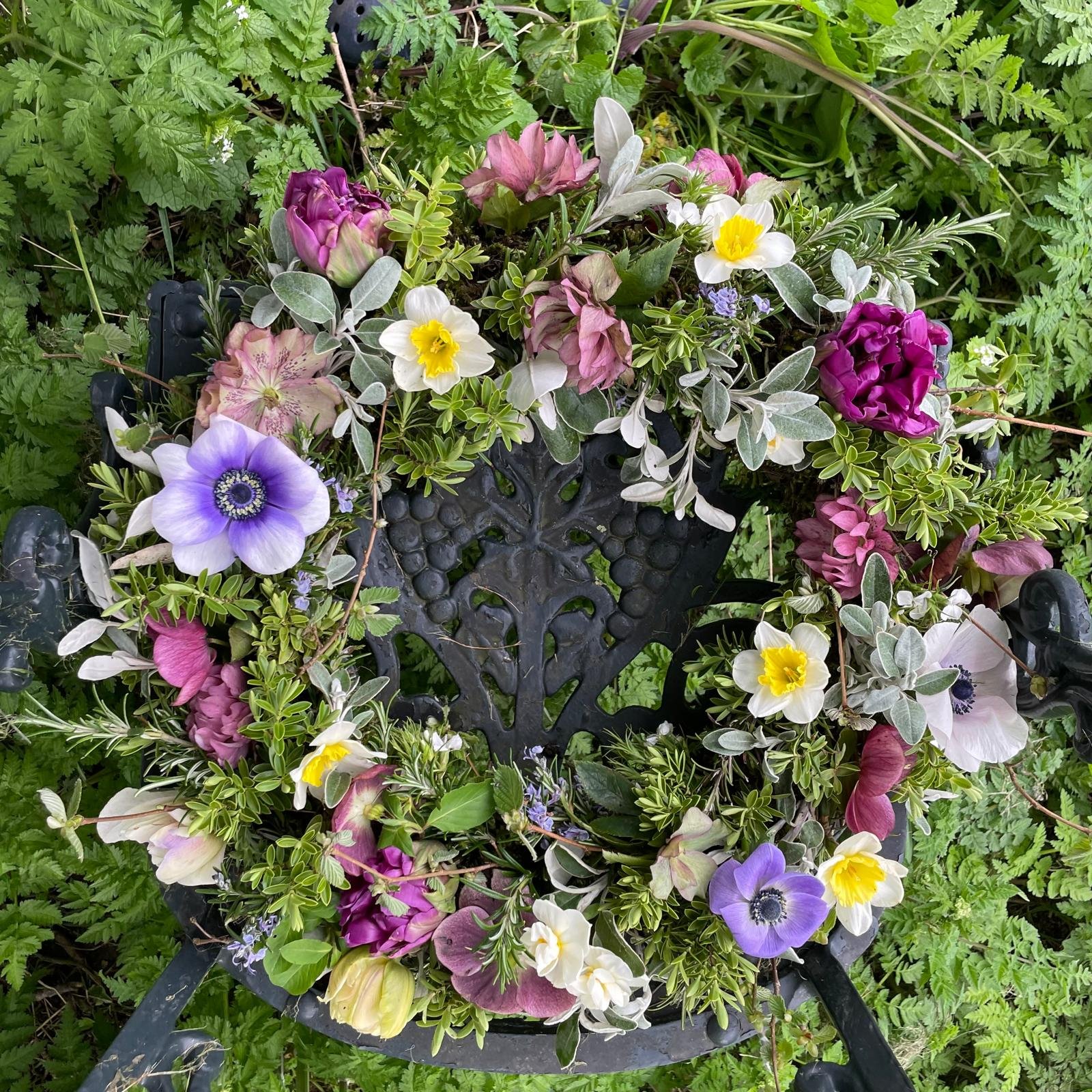 Wreath with spring flowers on a willow and moss base. Fully compostable