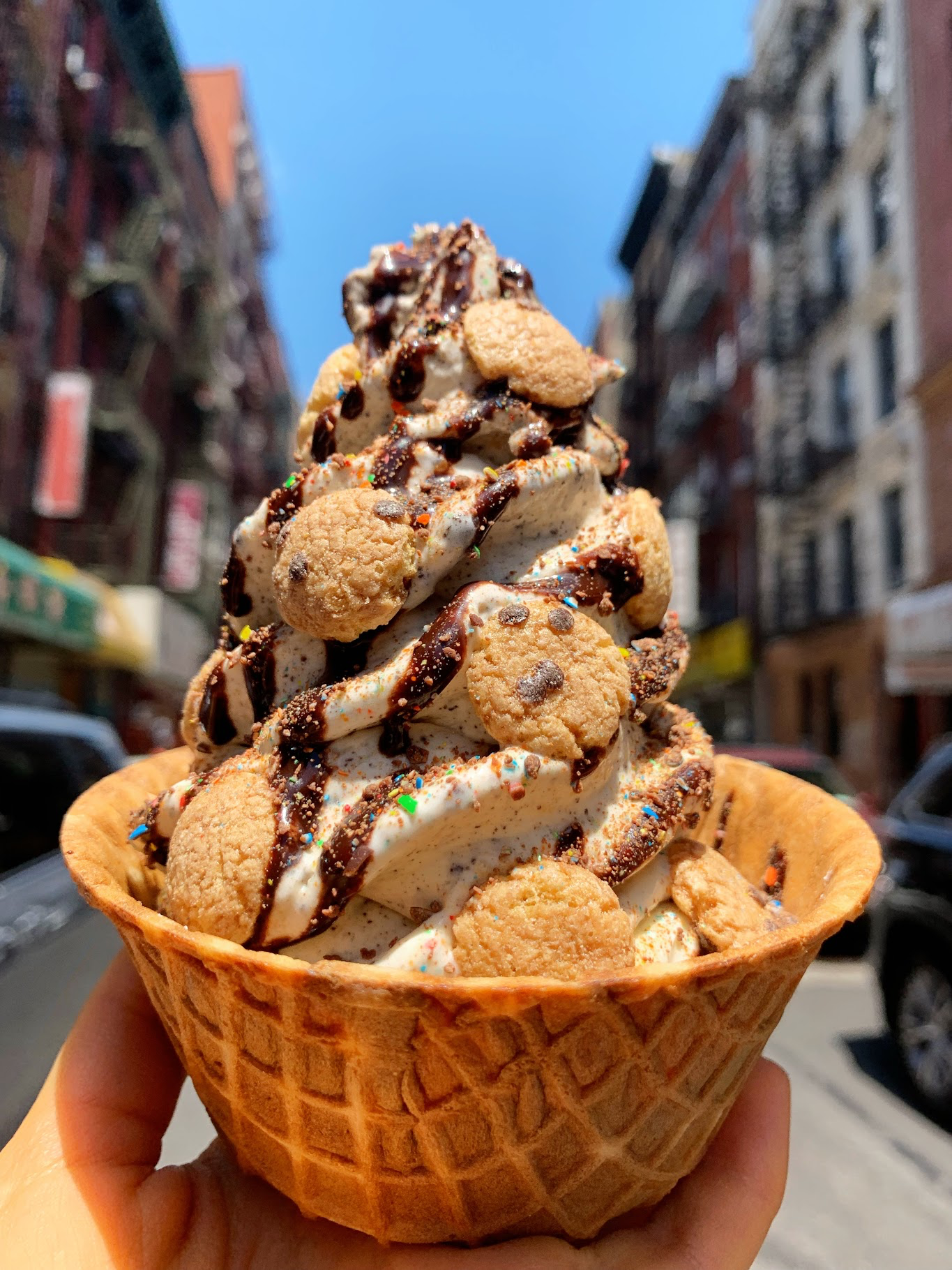 Waffle Cup, Blend of Cookie Crisp Carnival, topped with: Chocolate Drizzle, Crushed m&amp;ms, and Cookie Crisps