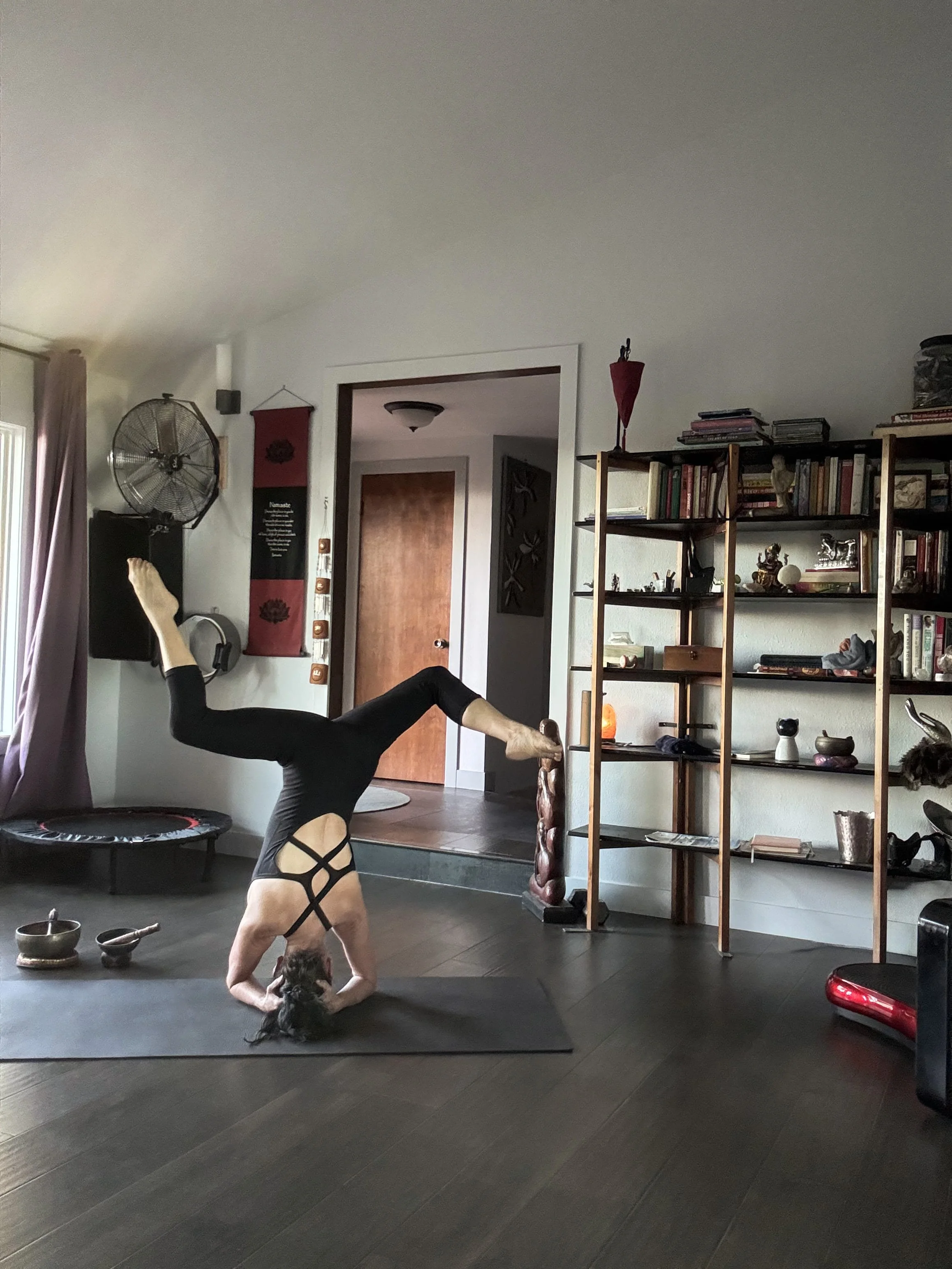 Yogi and fitness expert the Guru of Nuru Bendy Girl does handstand in Las Vegas workout room. Flexibility of the body will give flexibility of the mind.