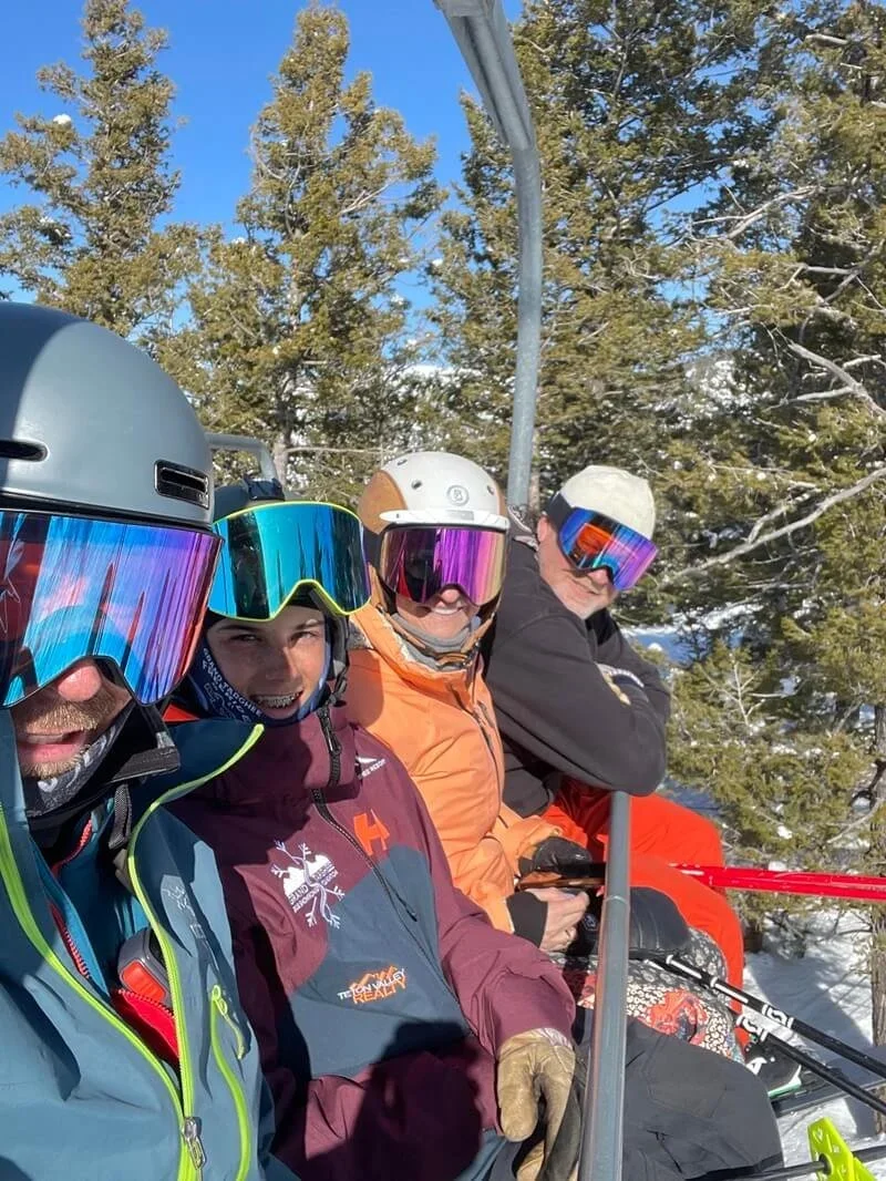 Skiers wearing Das Optics goggles on a bluebird powder day
