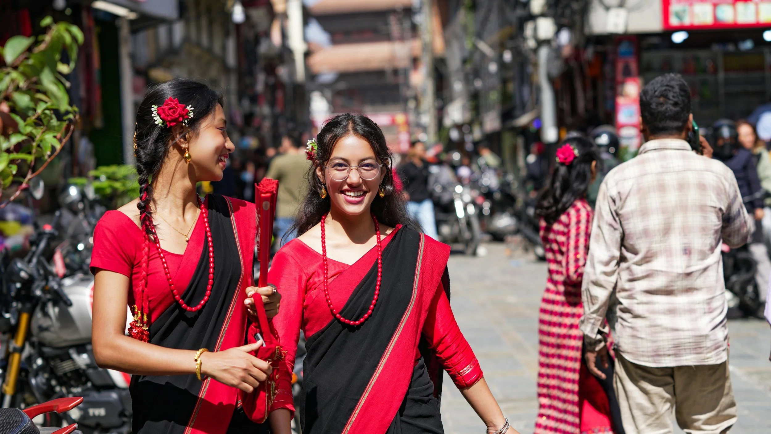 South Asian sisters laughing while walking