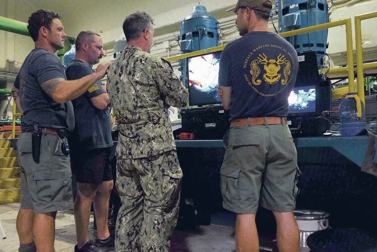 While their families got sick from contaminated water, these Navy divers were tasked with fixing it