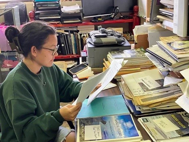 Volunteer Summer Wong reviews, organizes, and collates Maui Group’s water research archives.