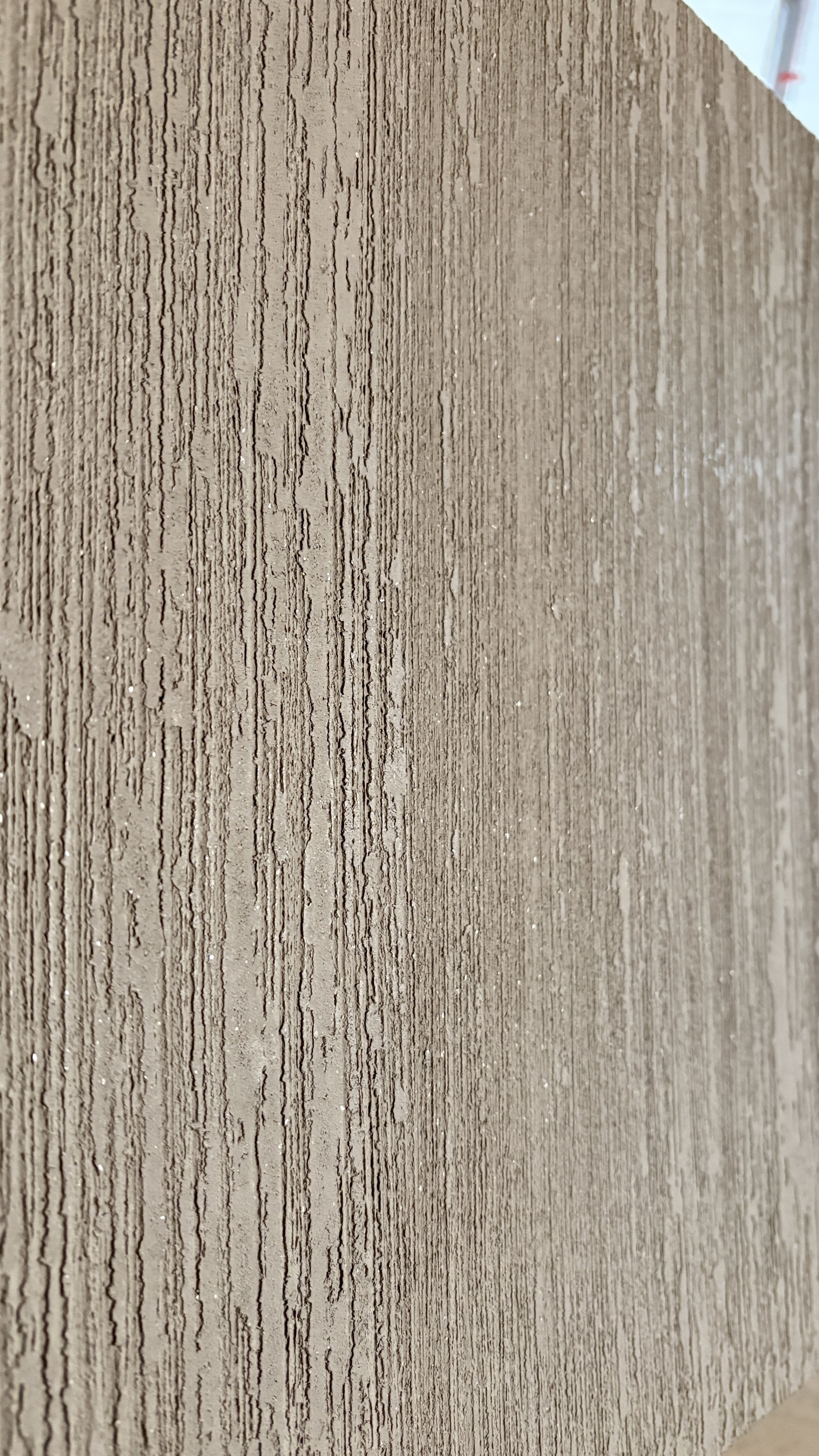 Close-up of a textured brown wooden surface with vertical lines.
