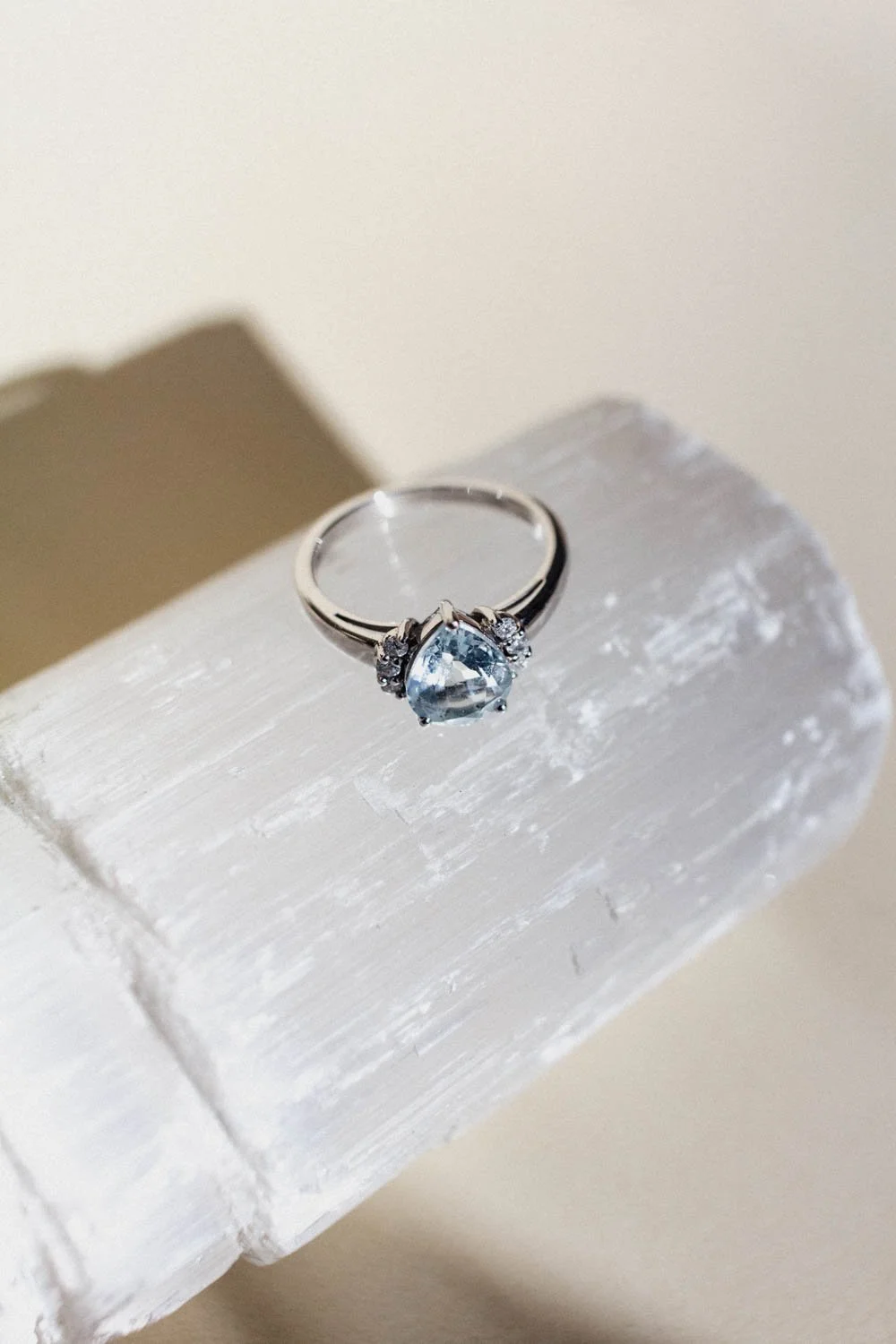 A diamond ring on a stone with rainbow-coloured highlights