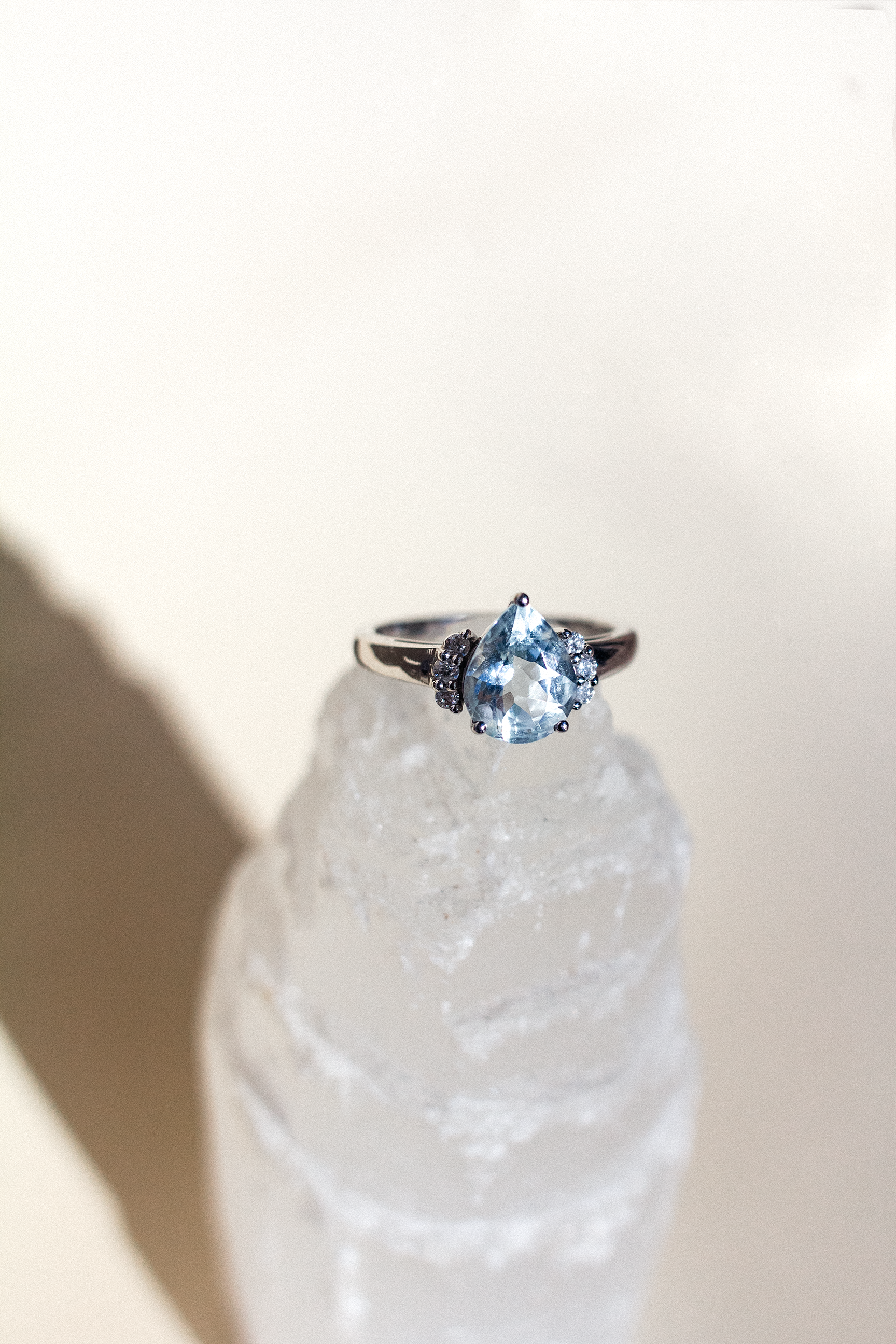 A diamond ring on a stone with rainbow-coloured highlights