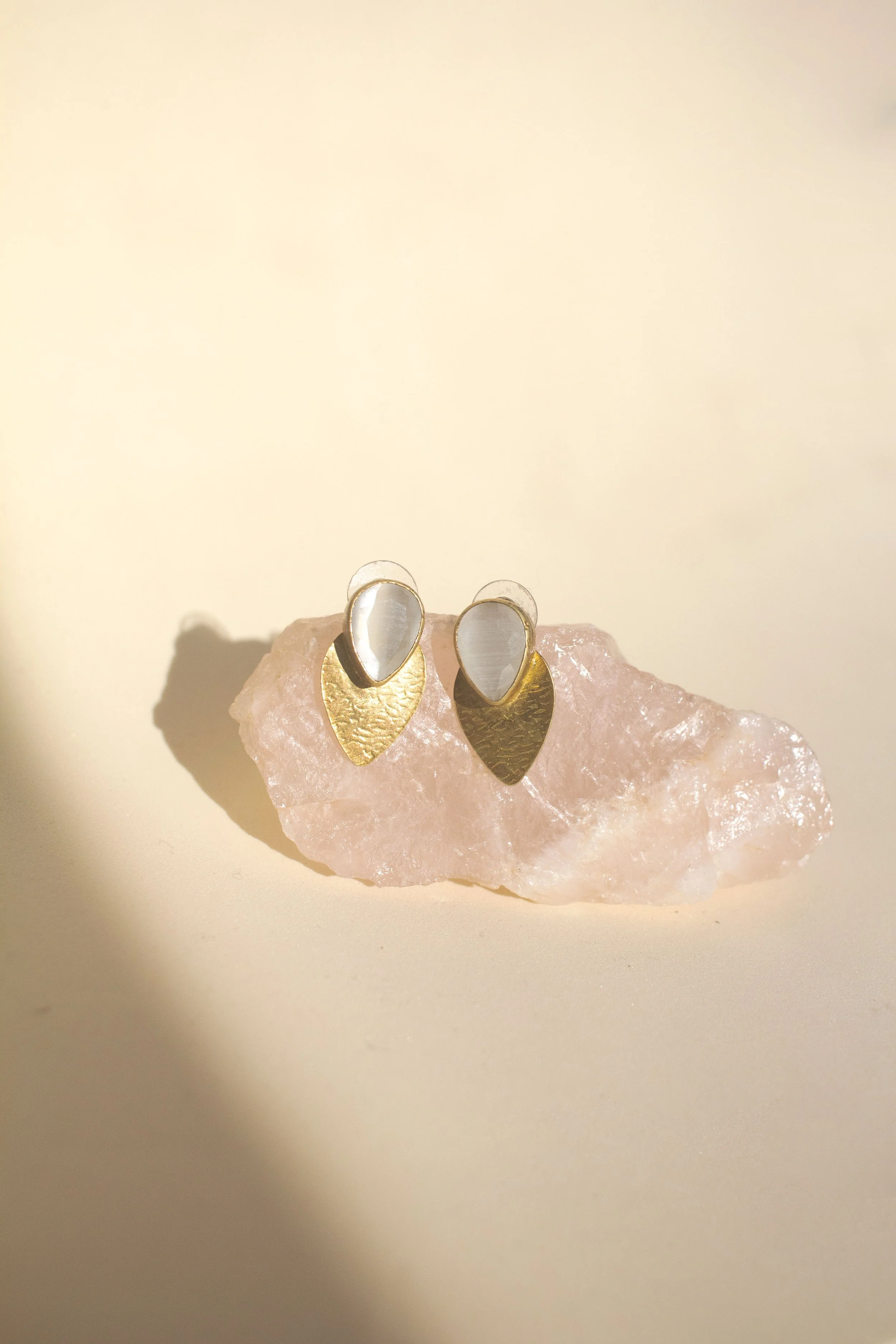Gold earring with white stone