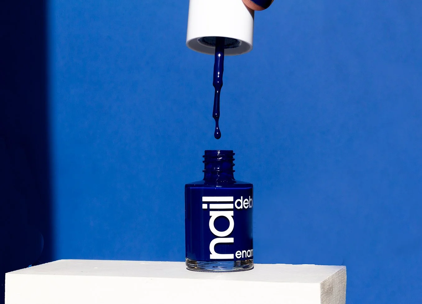 Blue nail color with white botton in blue background 