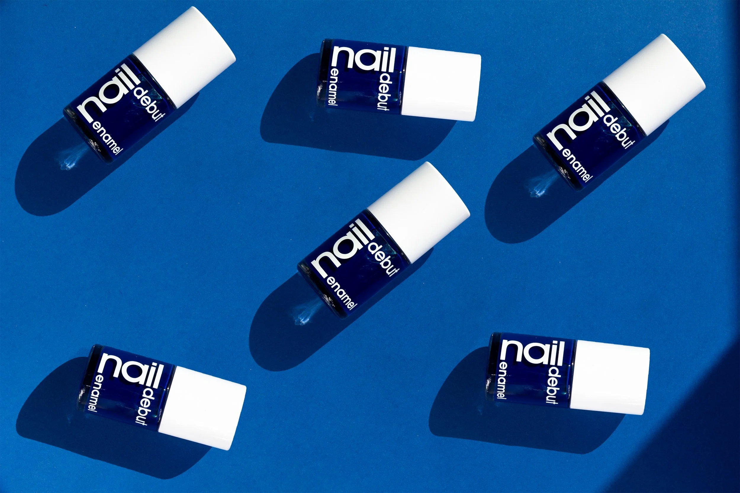 Blue nail color with white botton in blue background 